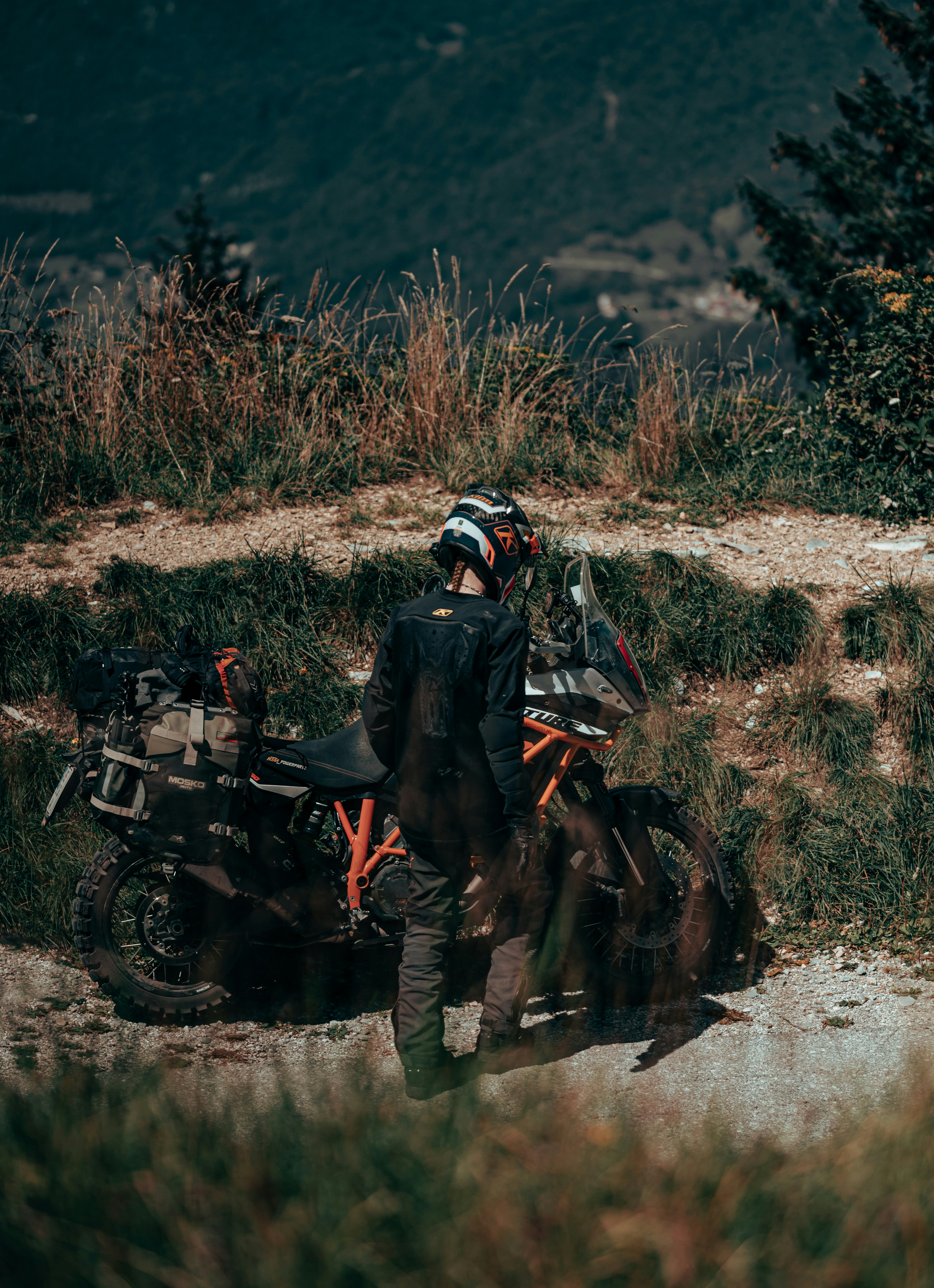 A man riding a motorcycle down a dirt road