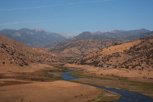 A river running through a valley surrounded by mountains