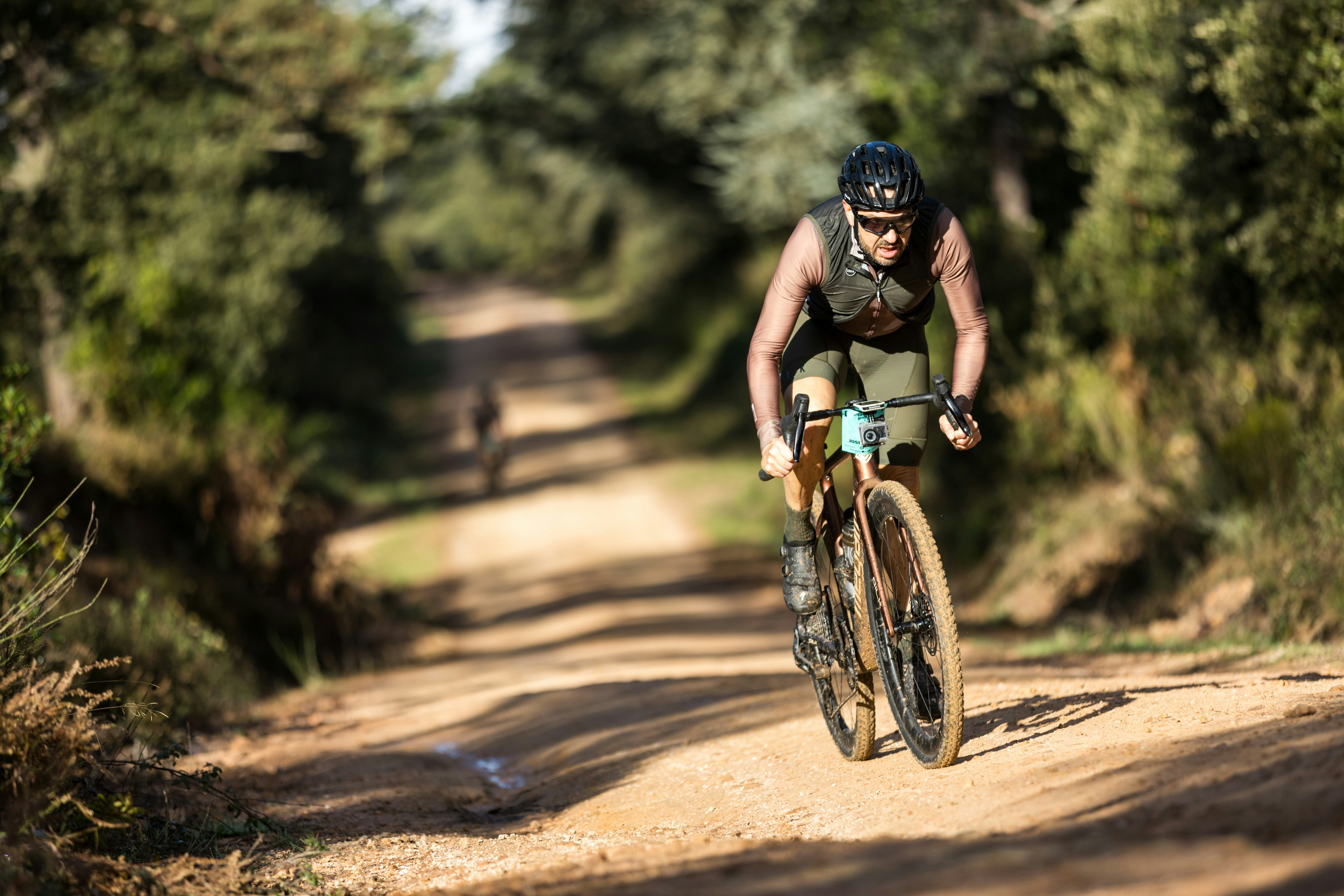 A man riding a bike down a dirt road