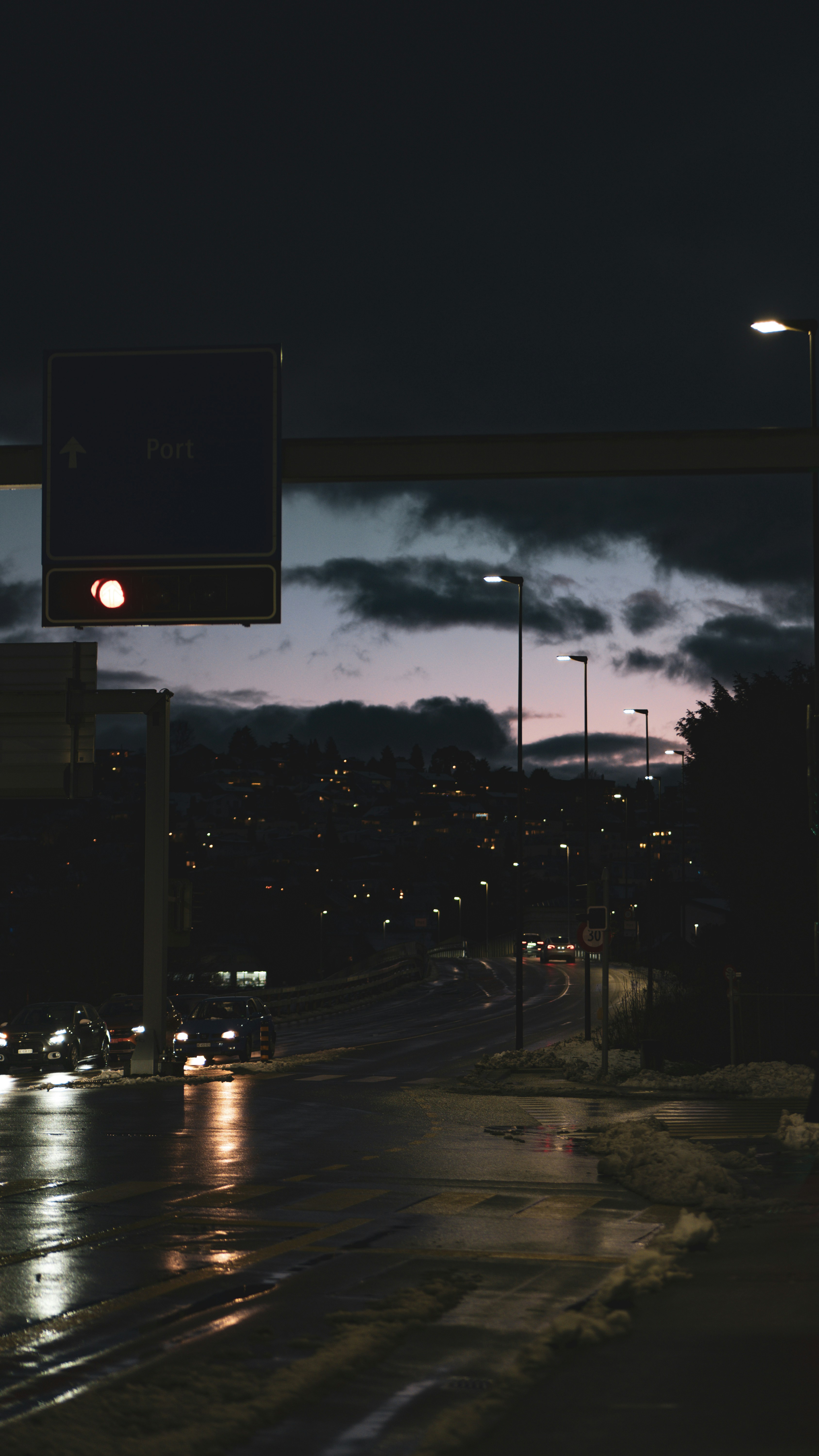 A city street at night with traffic lights and street signs photo ...