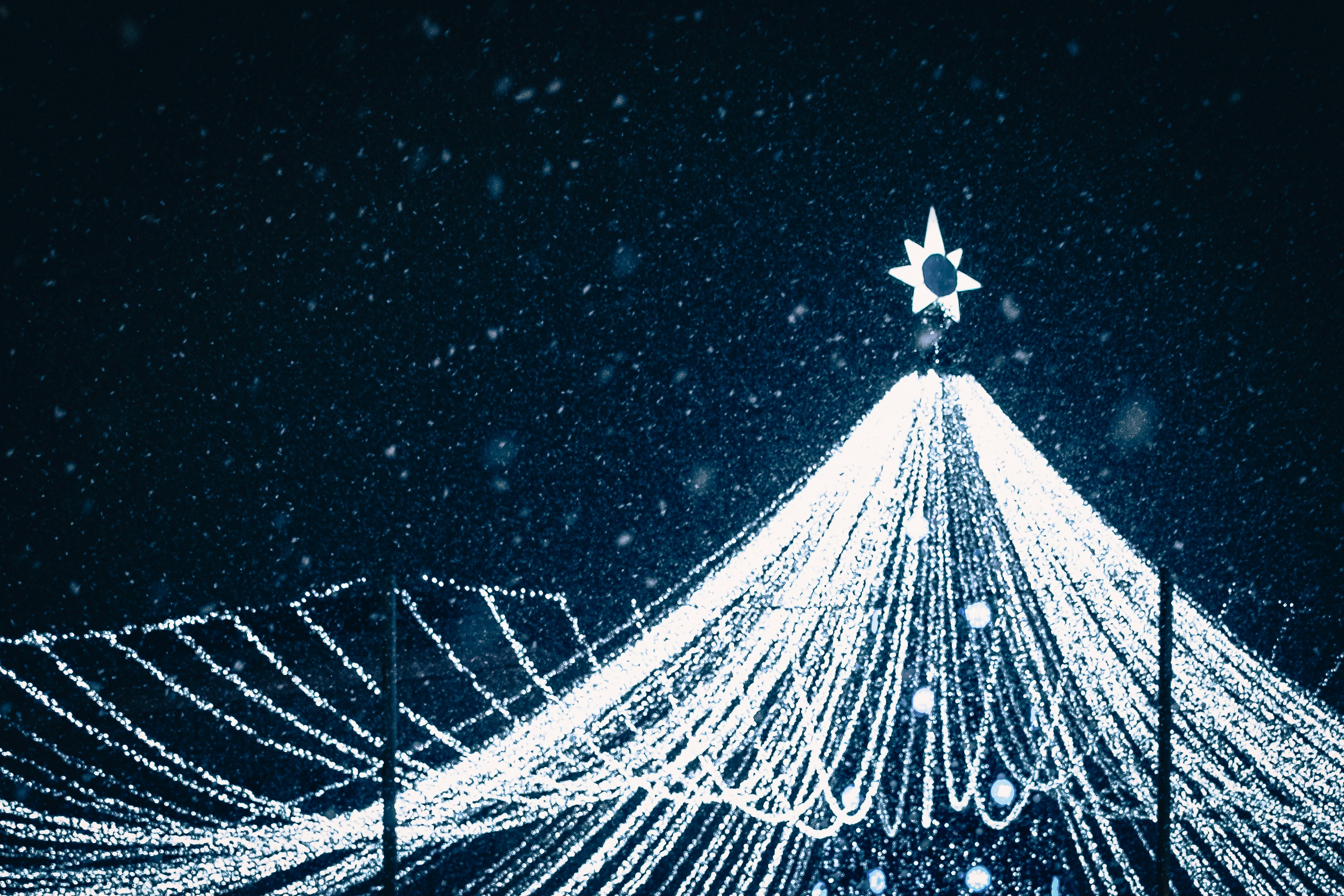 A white christmas tree with a star on top