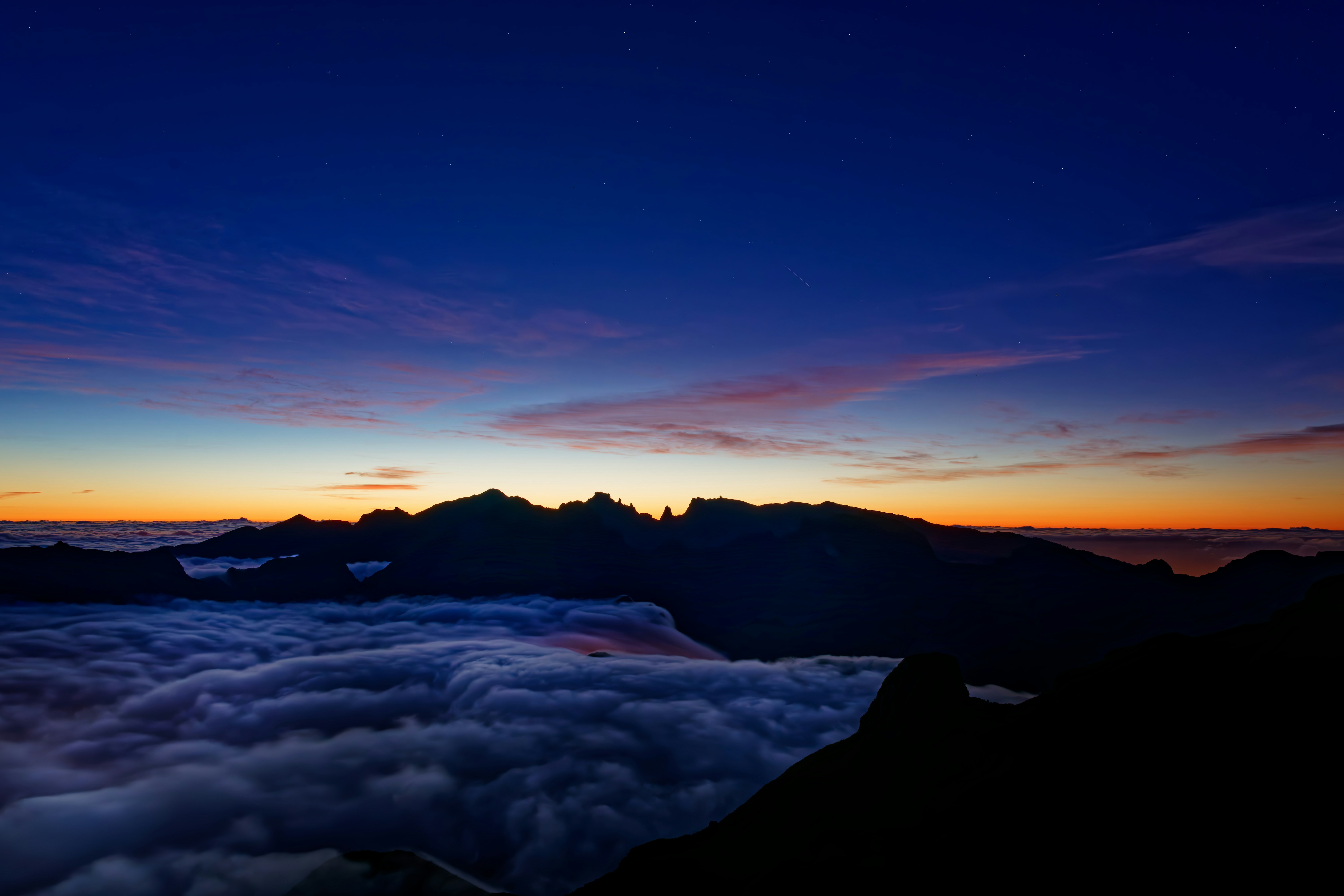 A view of a mountain at night from a plane