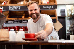 A man sitting at a counter with a red bowl