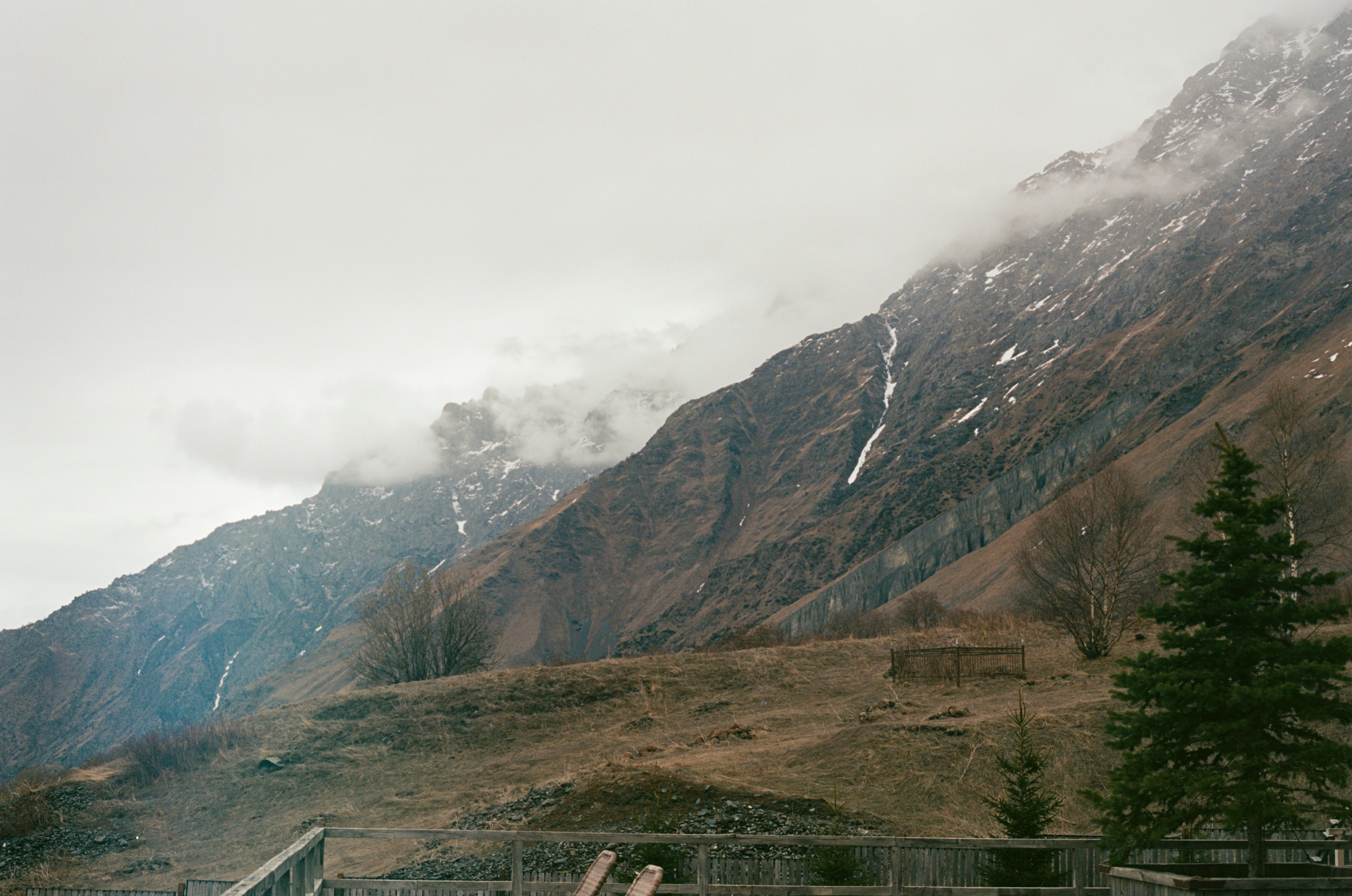 A man riding a snowboard down a snow covered slope