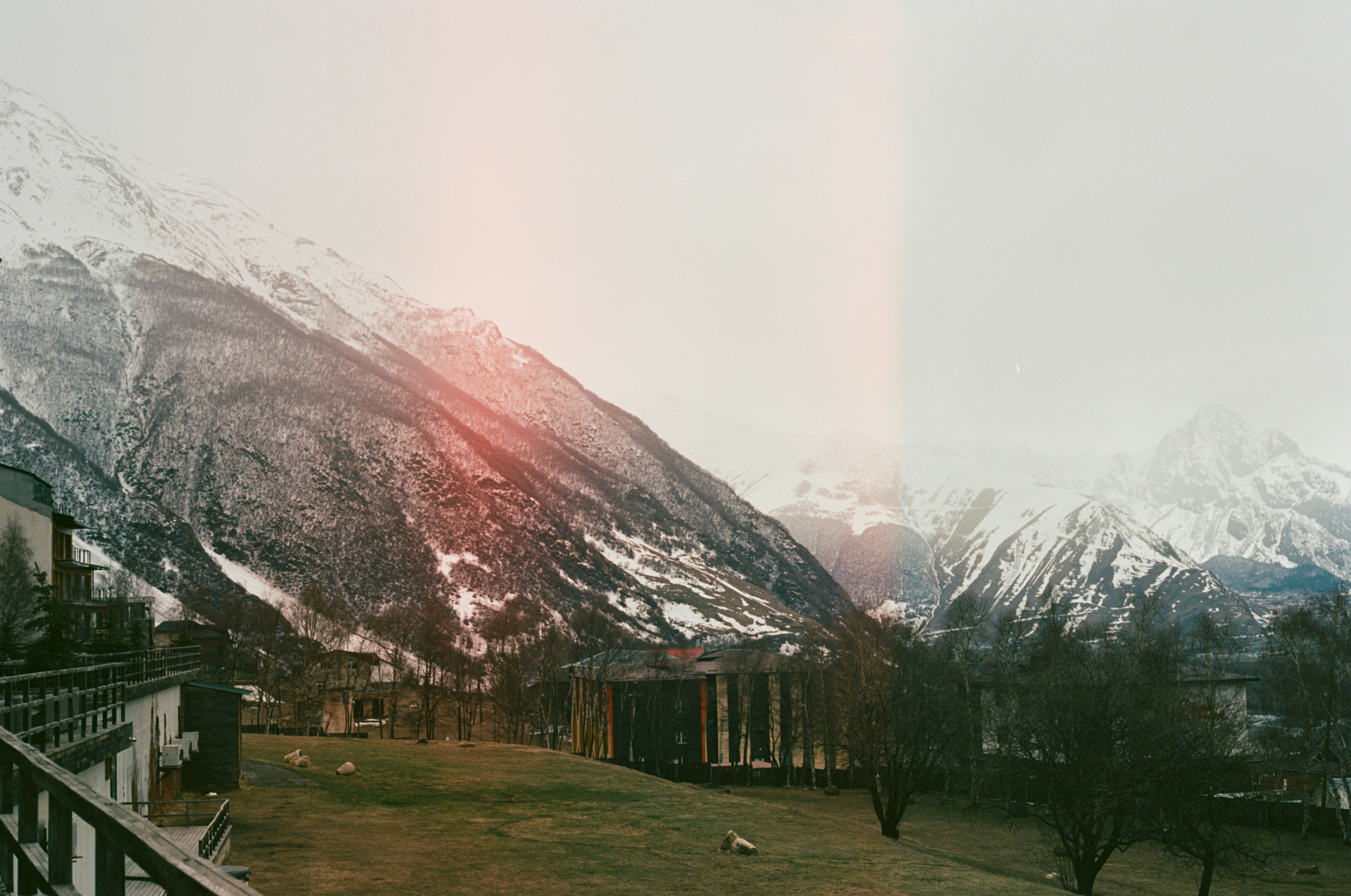 A view of a snow covered mountain range from a balcony