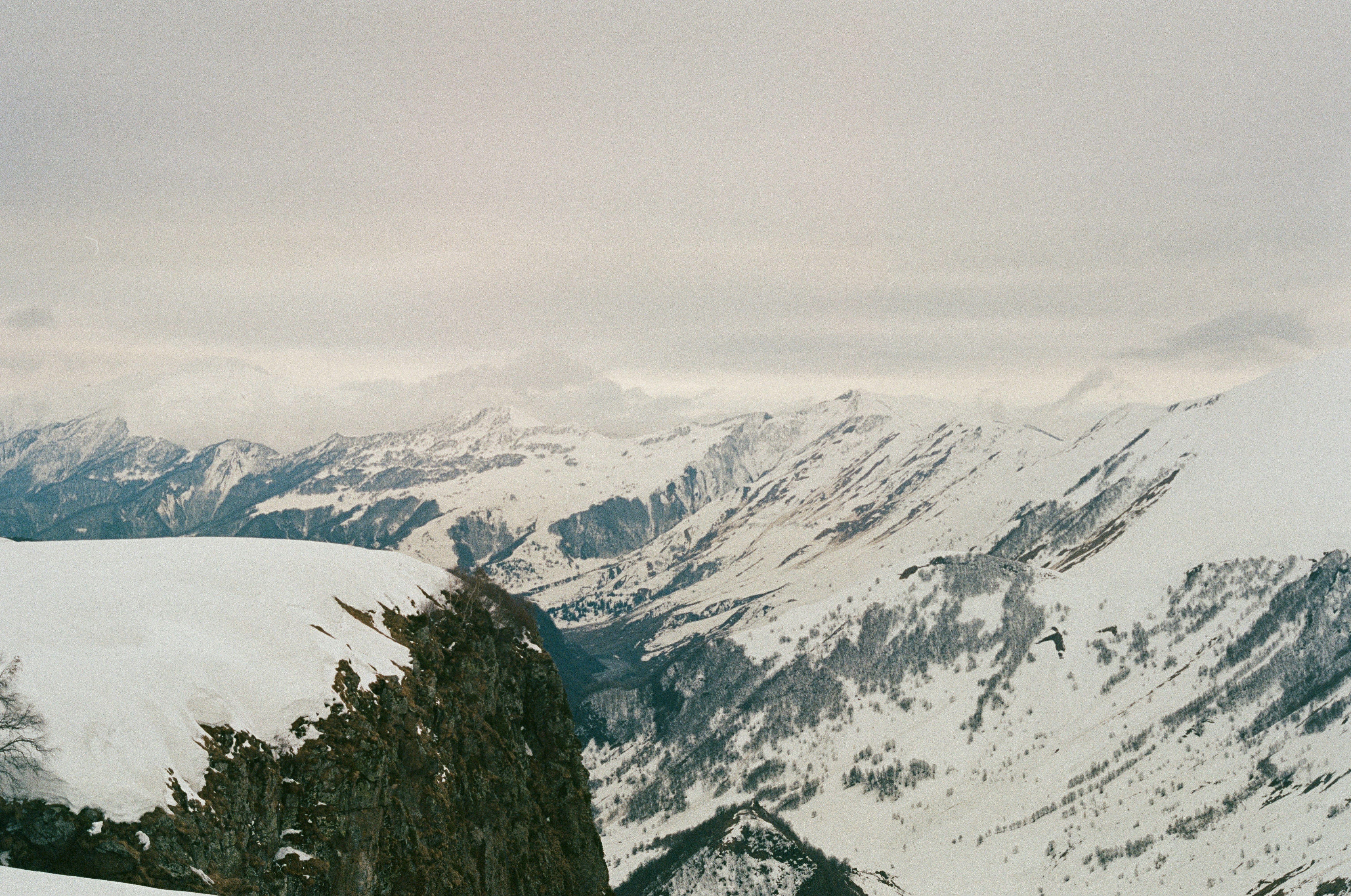 A man riding skis on top of a snow covered slope