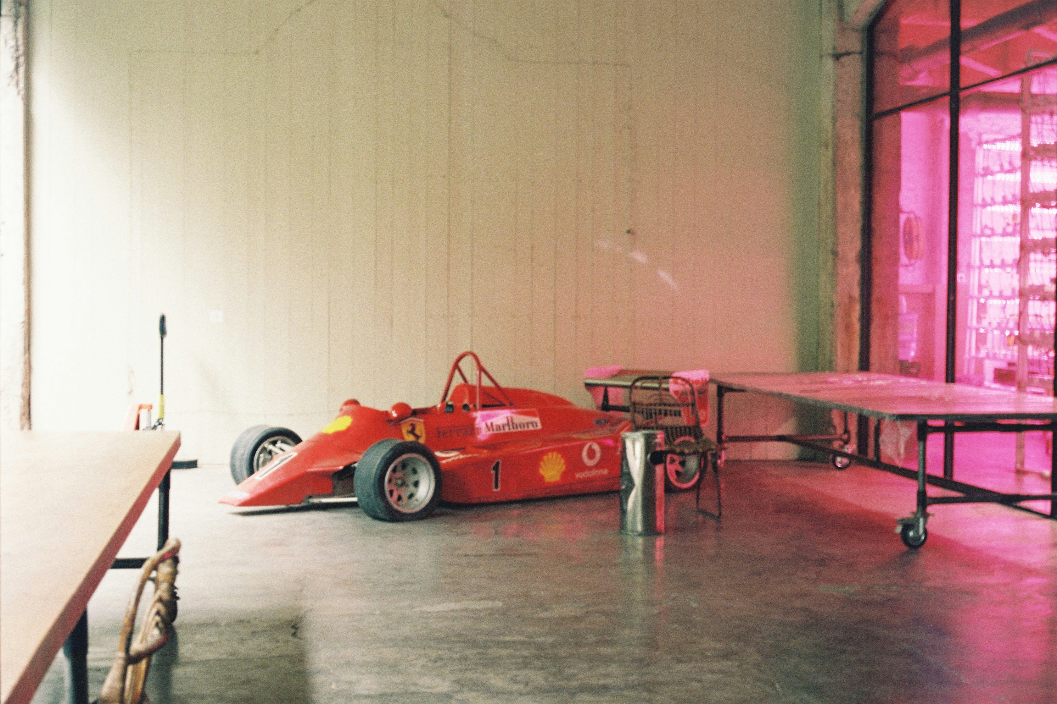 A red race car parked in a garage
