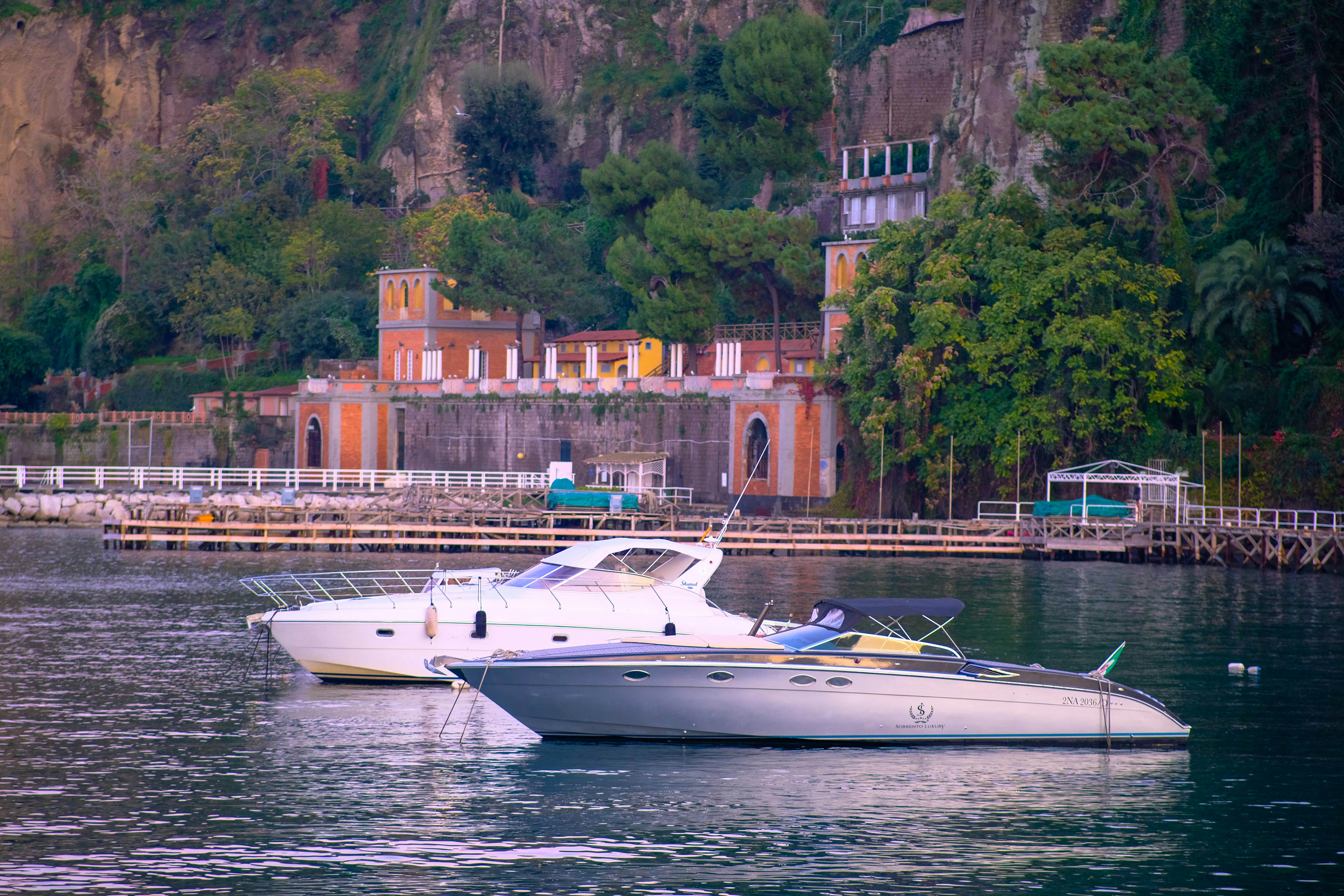 A couple of boats floating on top of a lake