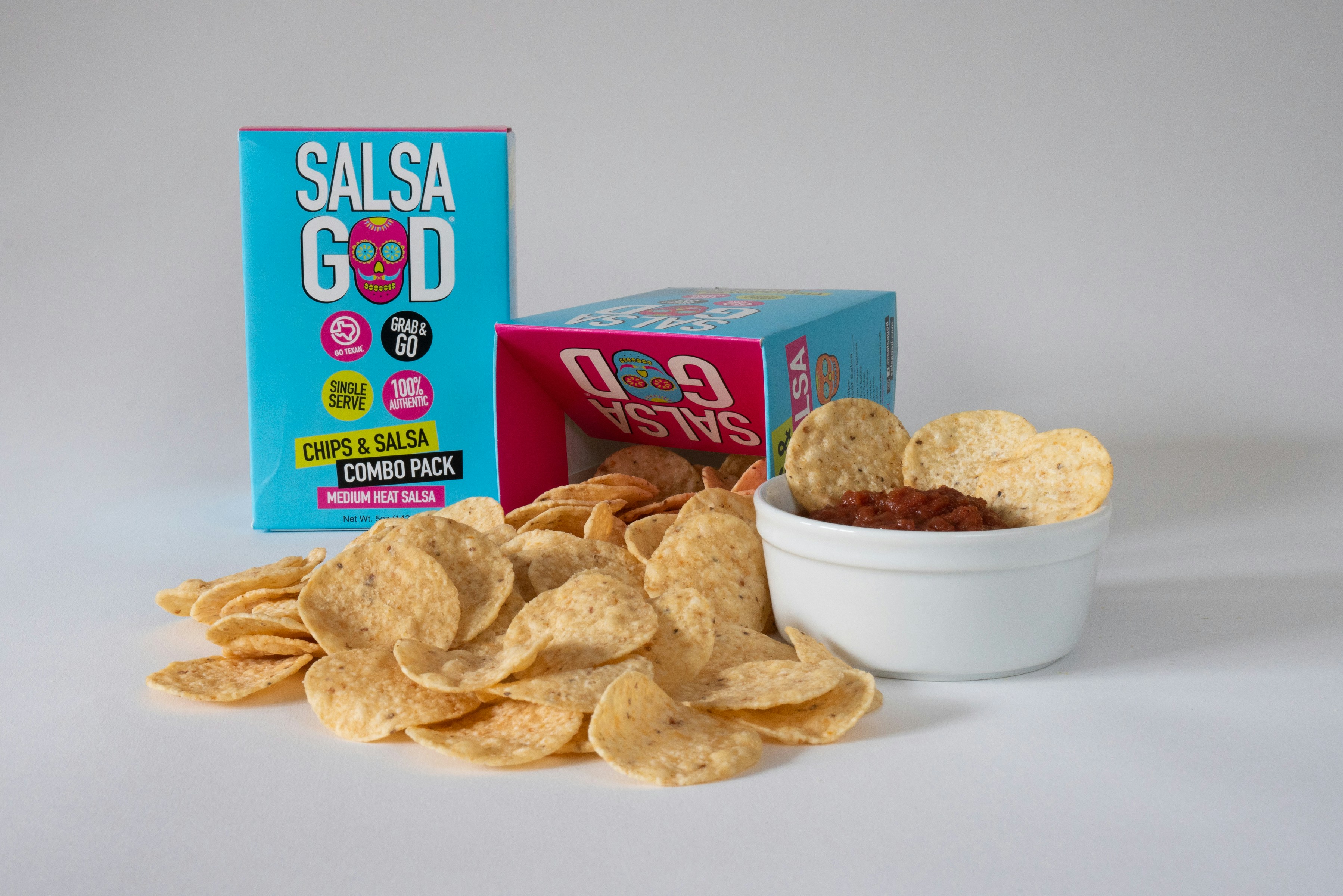 A bowl of chips next to a box of salsa