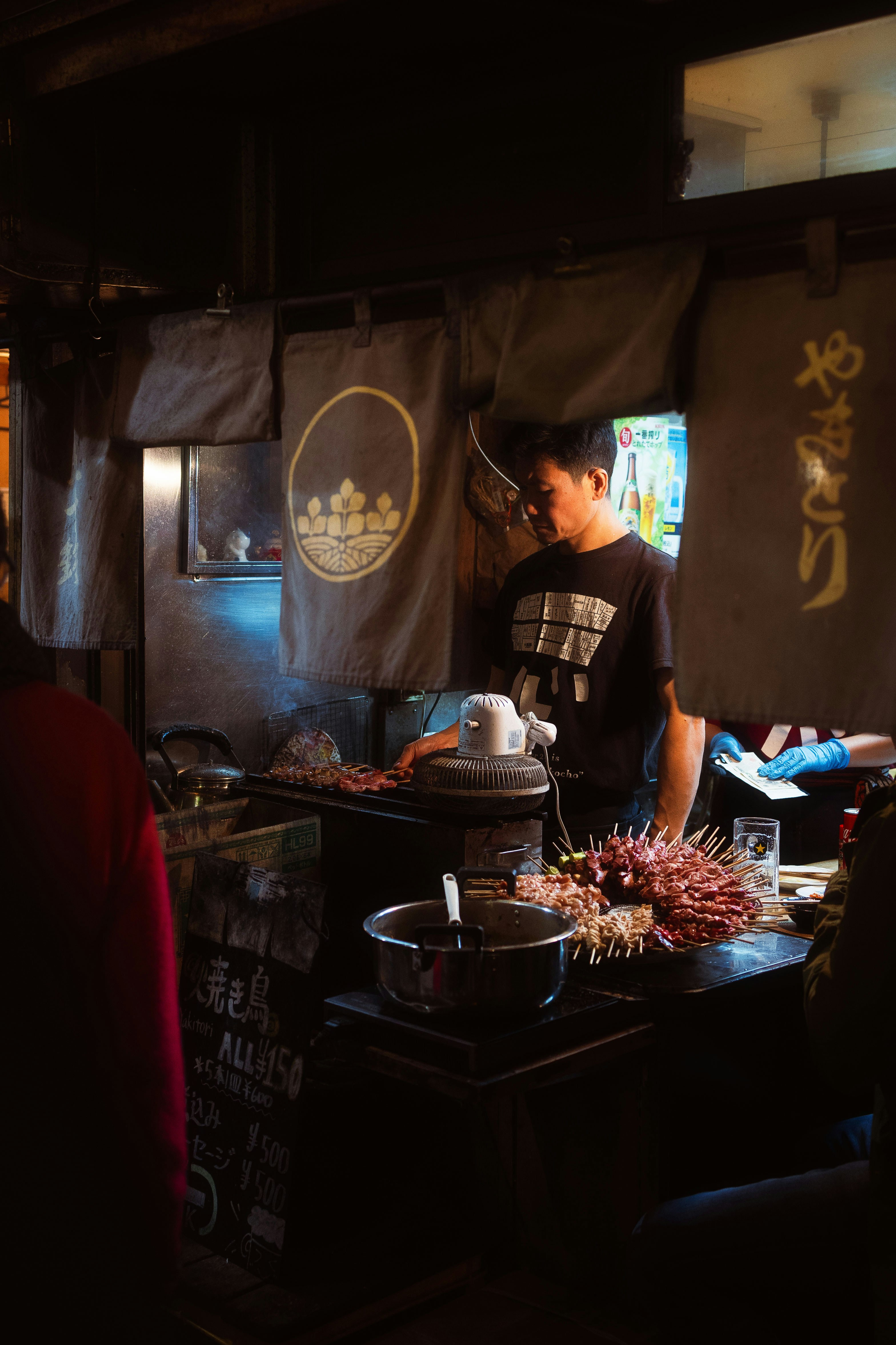 A group of people standing around a table with food on it