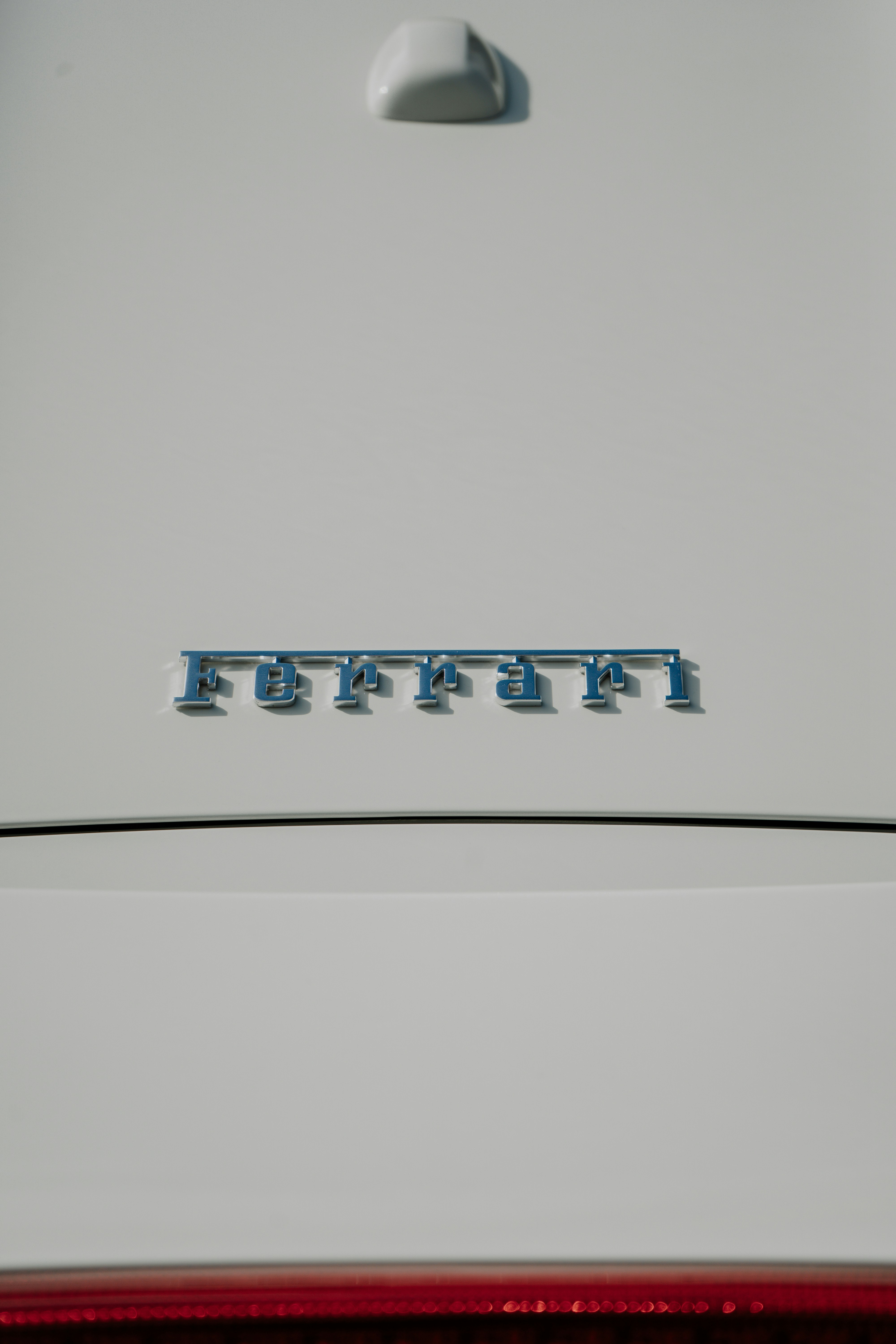 The emblem on the back of a white car