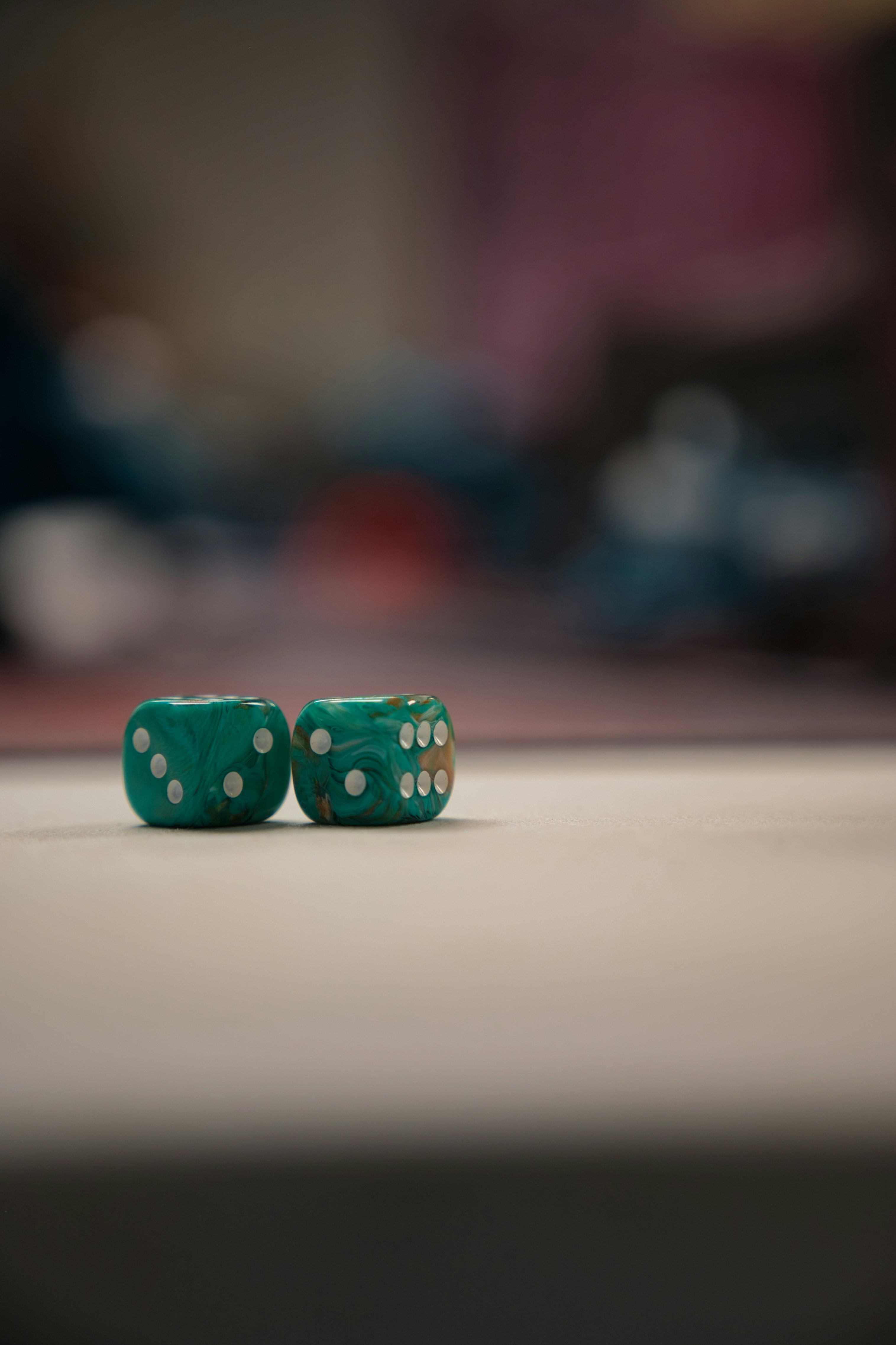 Two green dices sitting on top of a table