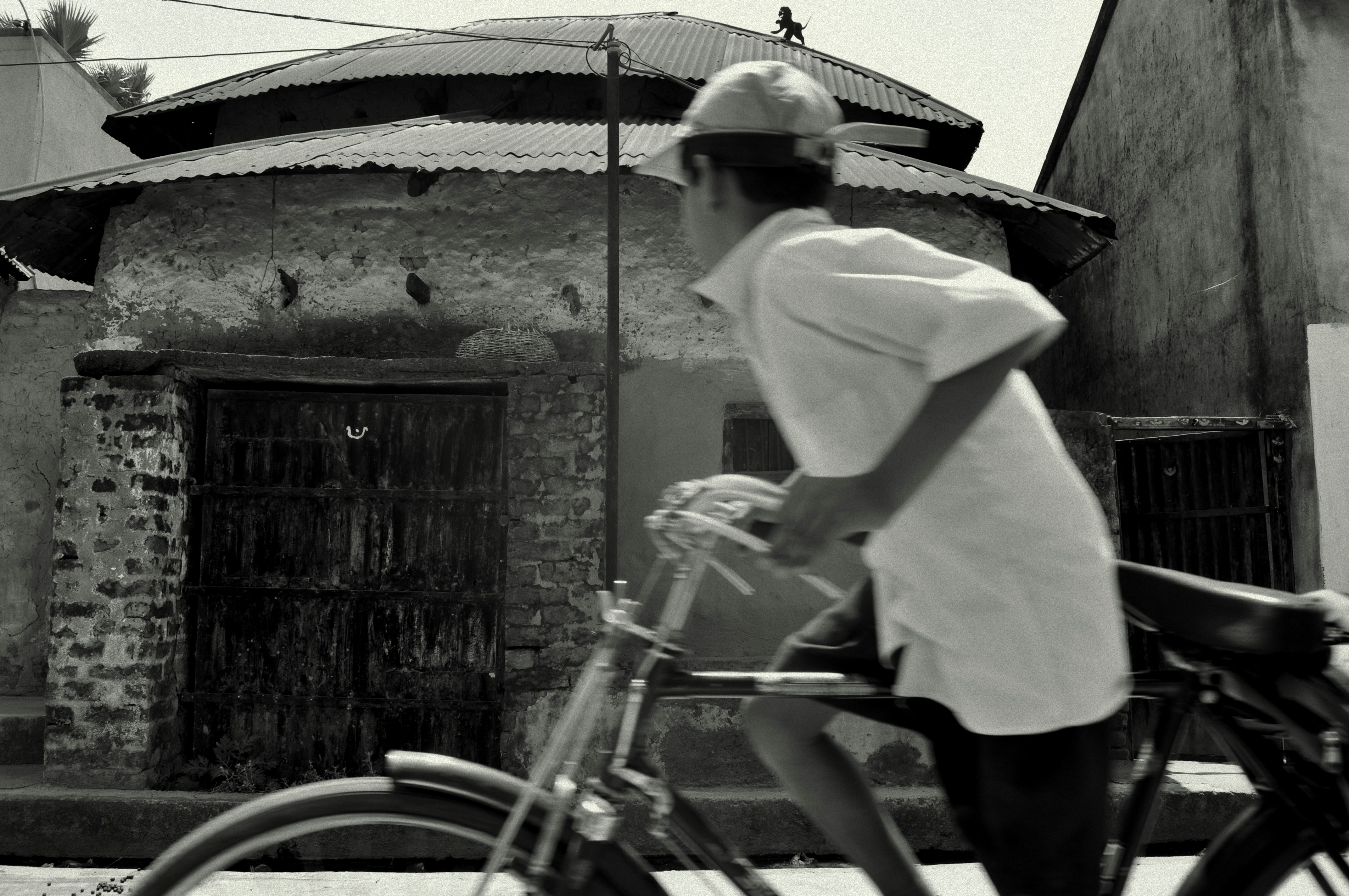 A man riding a bike down a street