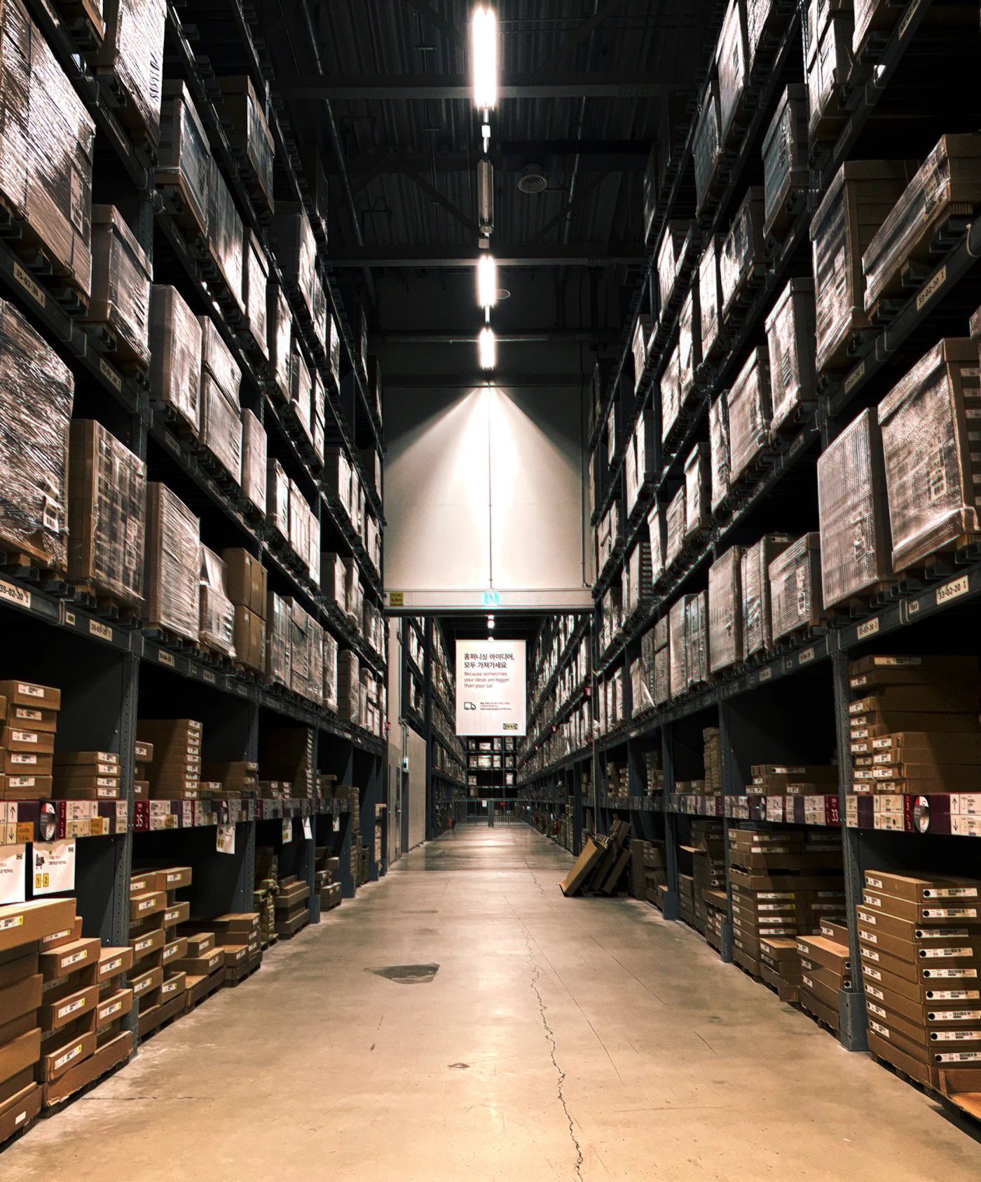 Warehouse shelves stacked with boxes, representing the storage side of logistics services