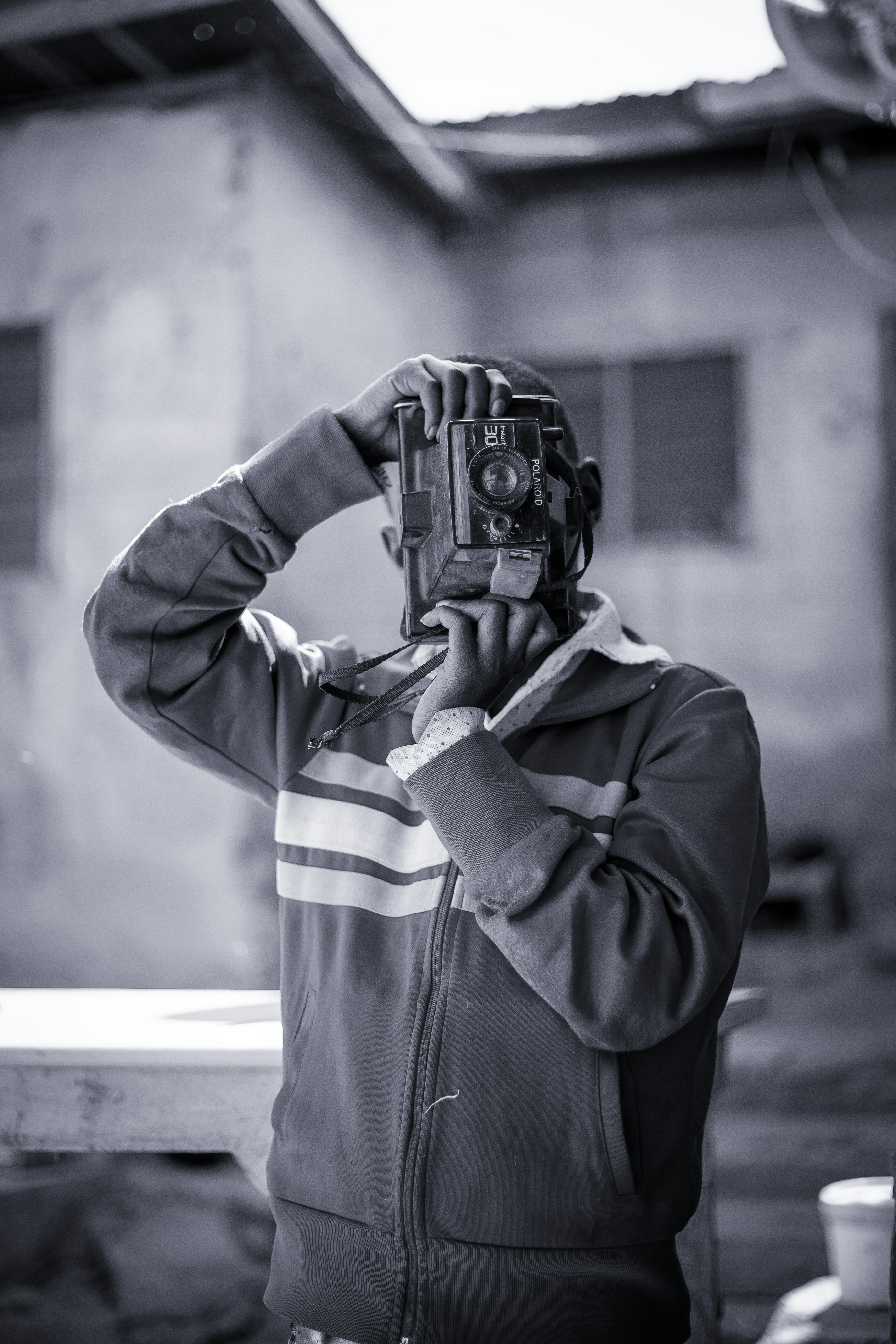 A man holding a camera up to his face