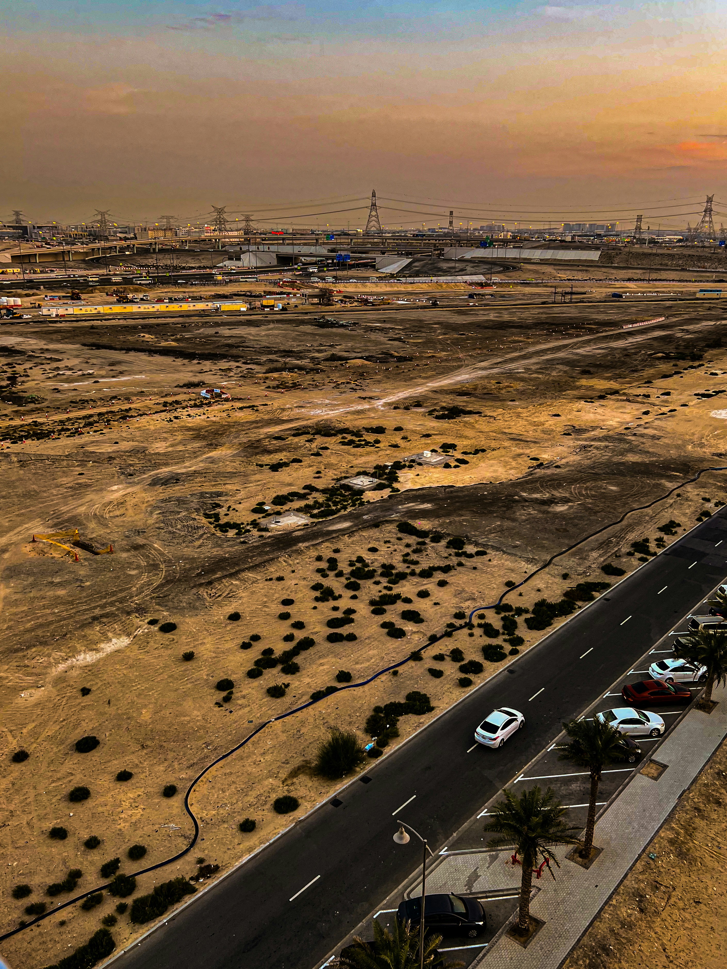 Desert landscape with infrastructure overlays and satellite data visualization, dark atmospheric environmental imagery