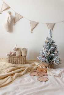 A bed with a christmas tree and stuffed animals on it
