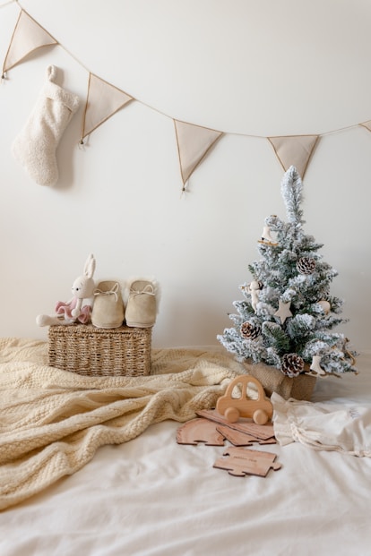 A bed with a christmas tree and stuffed animals on it