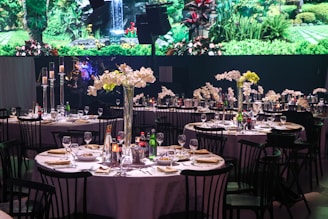 A large aquarium is in the background of a banquet table