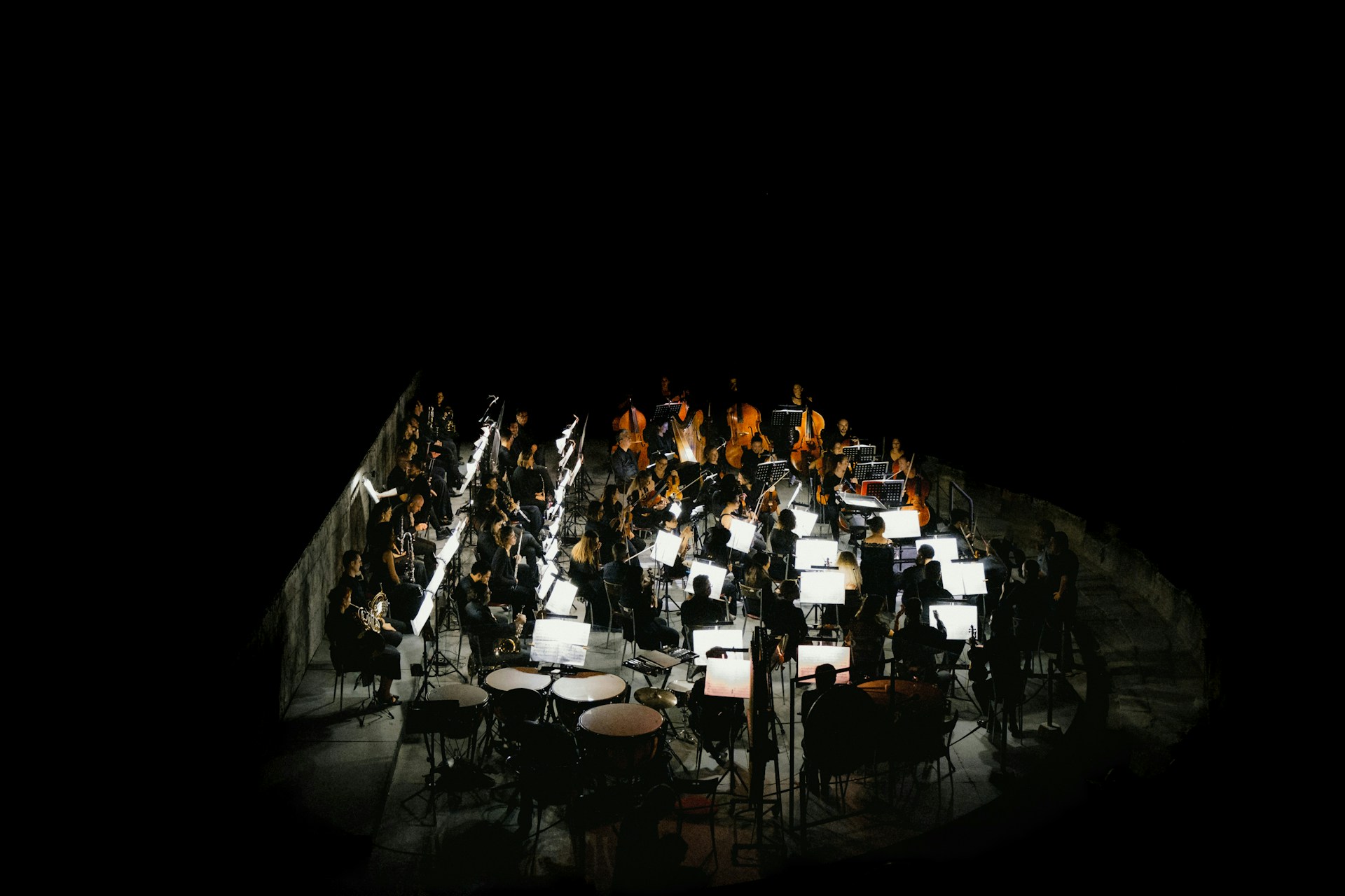 A large group of musical instruments on a black background
