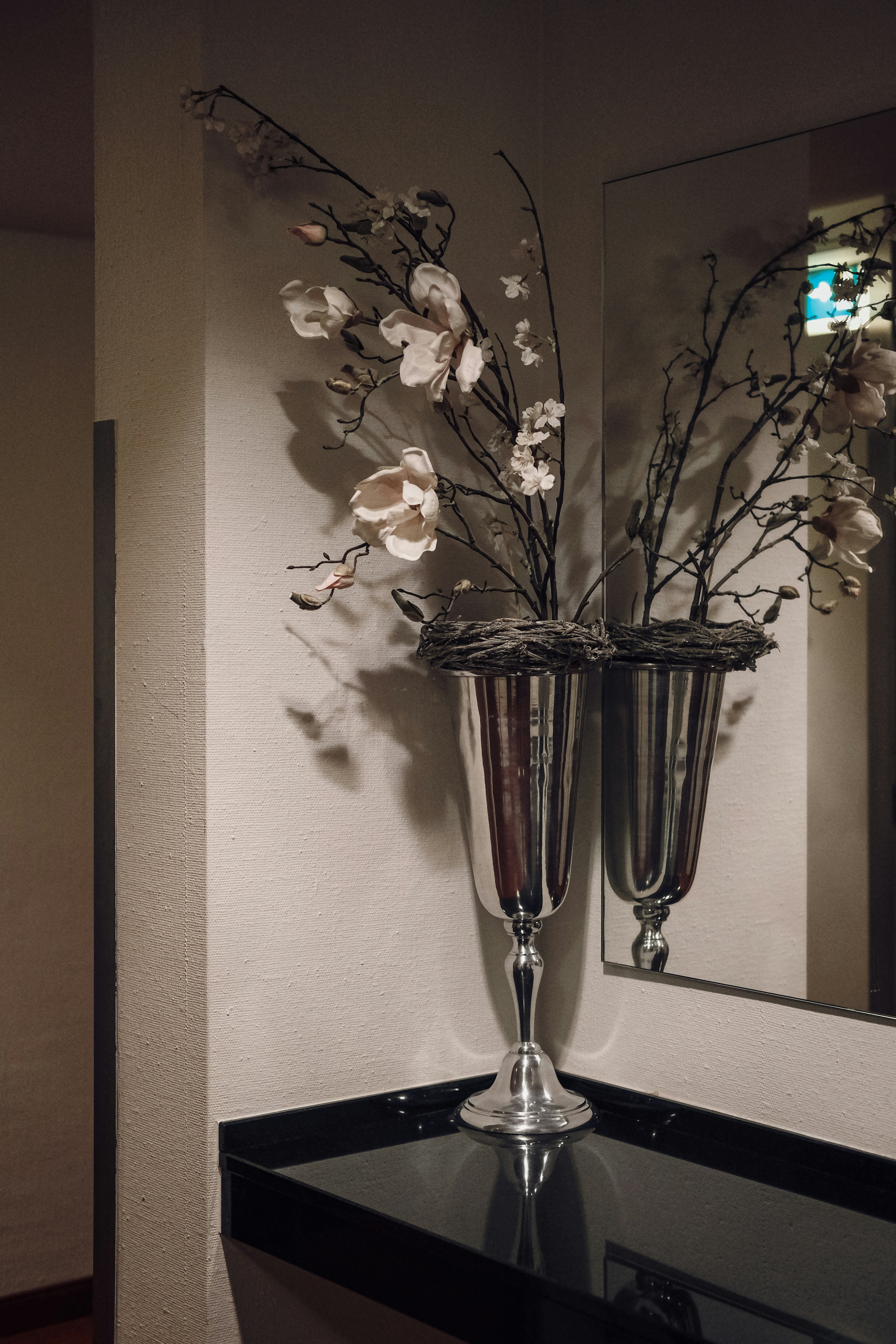 A vase with flowers on a black table