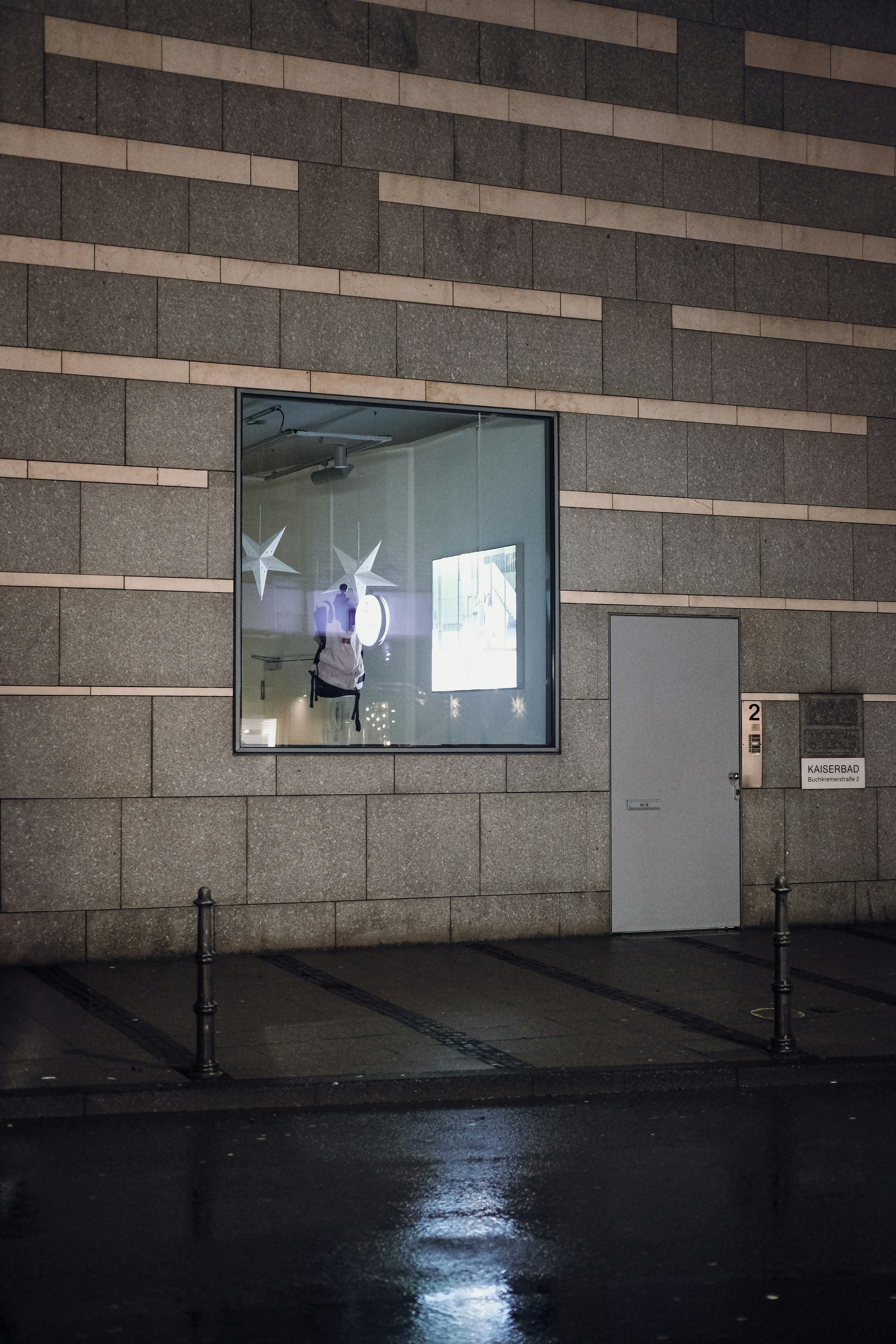 A building with a large window and a white door