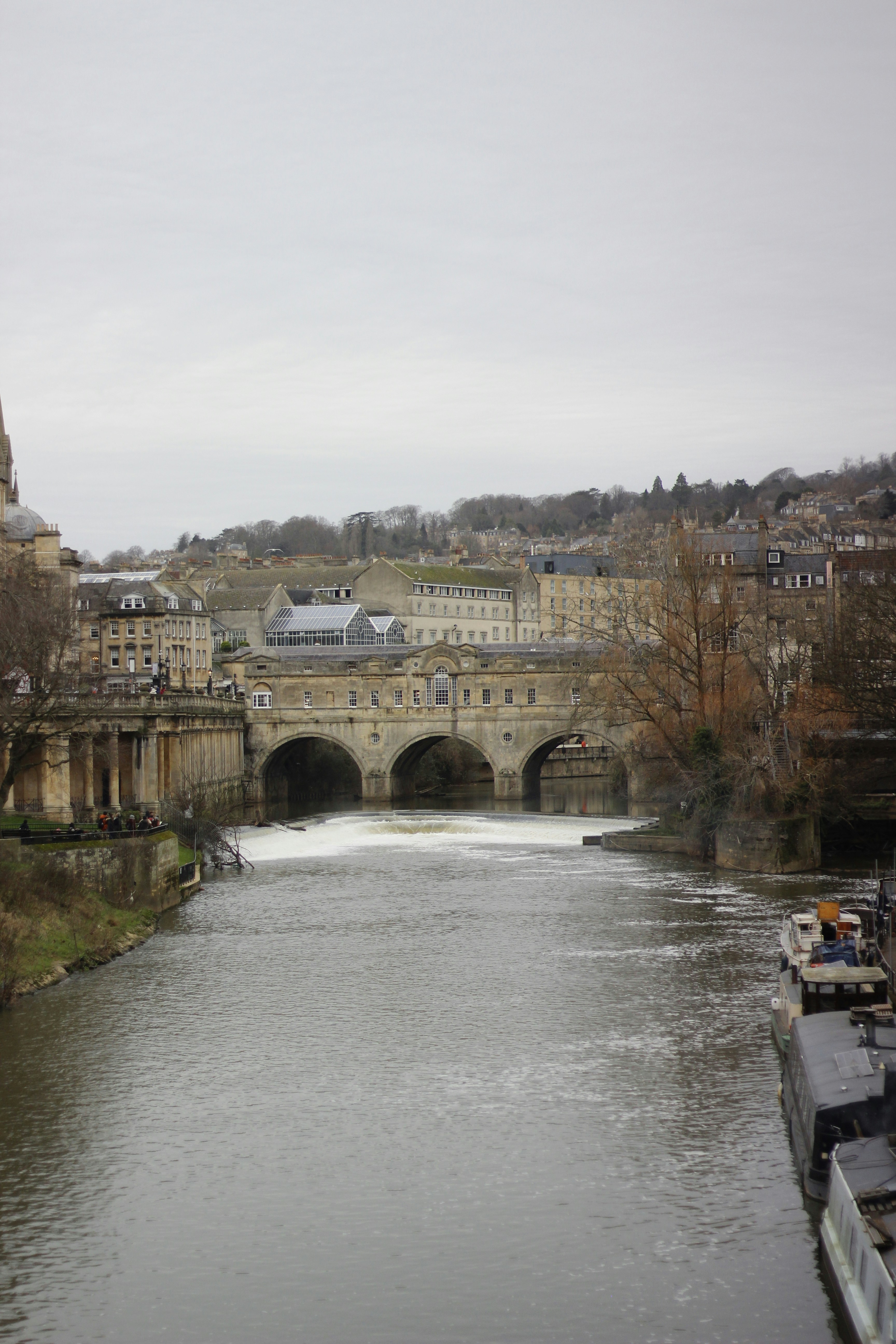 A river running through a city next to a bridge