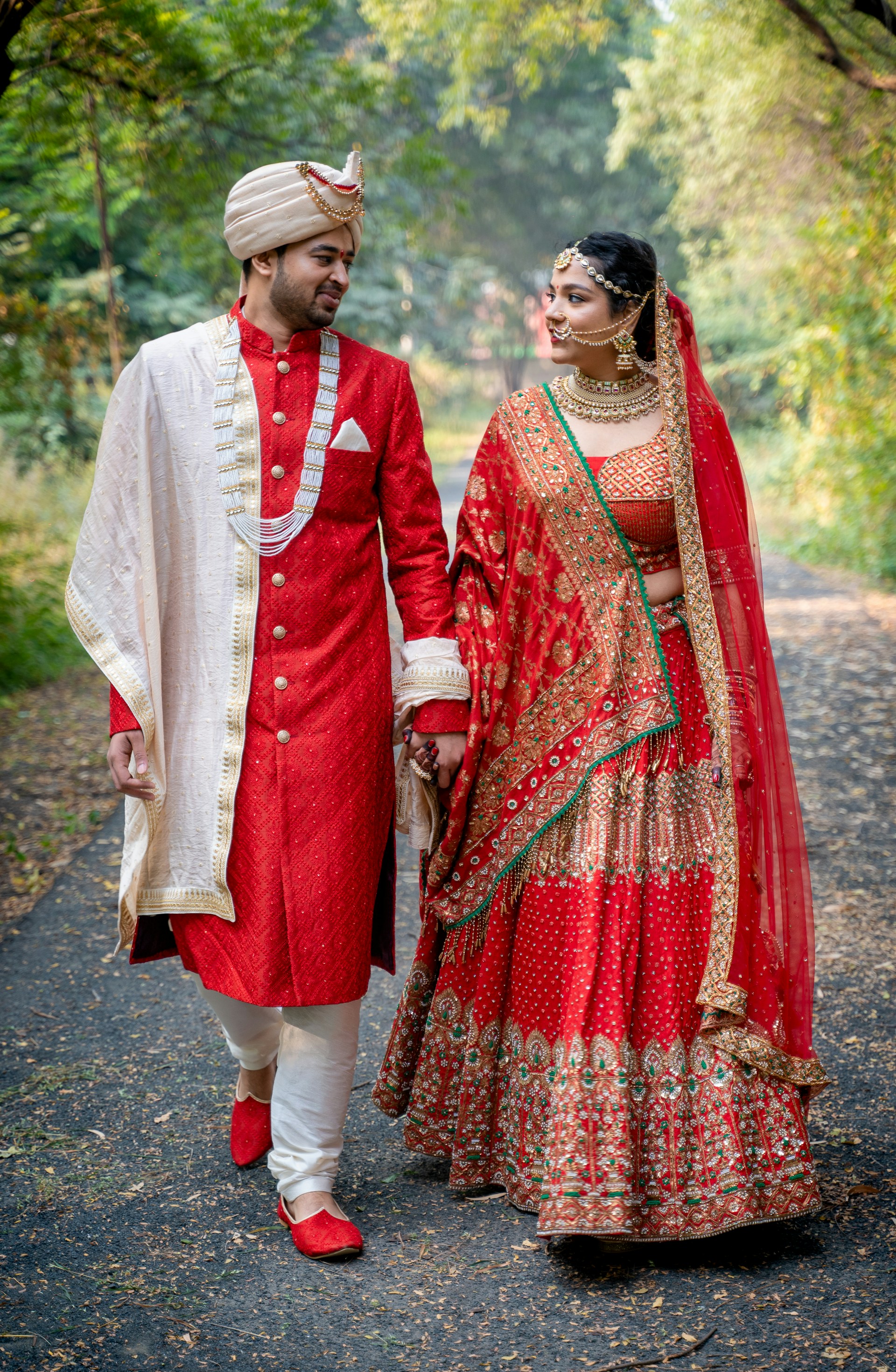 A bride and groom walking down a path