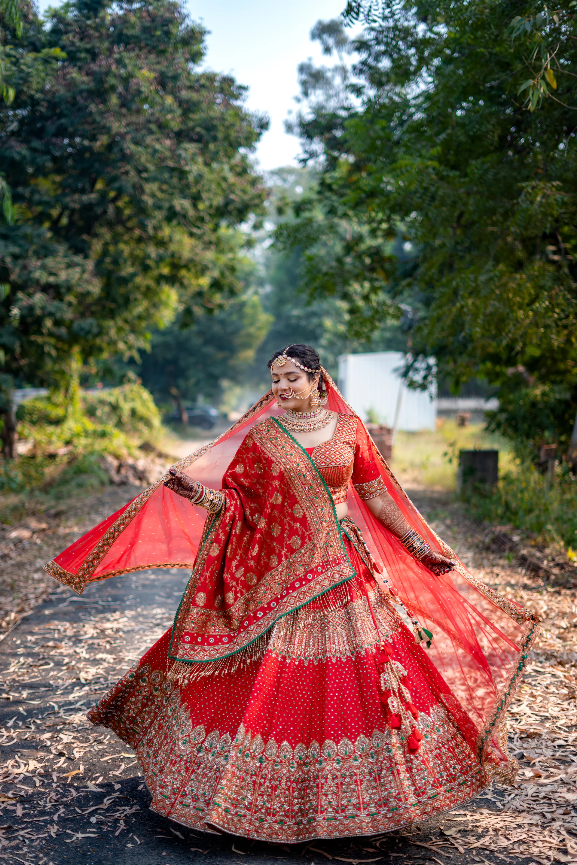 Woman in a red and gold lehenga