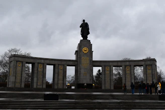 A monument with a statue of a man on top of it
