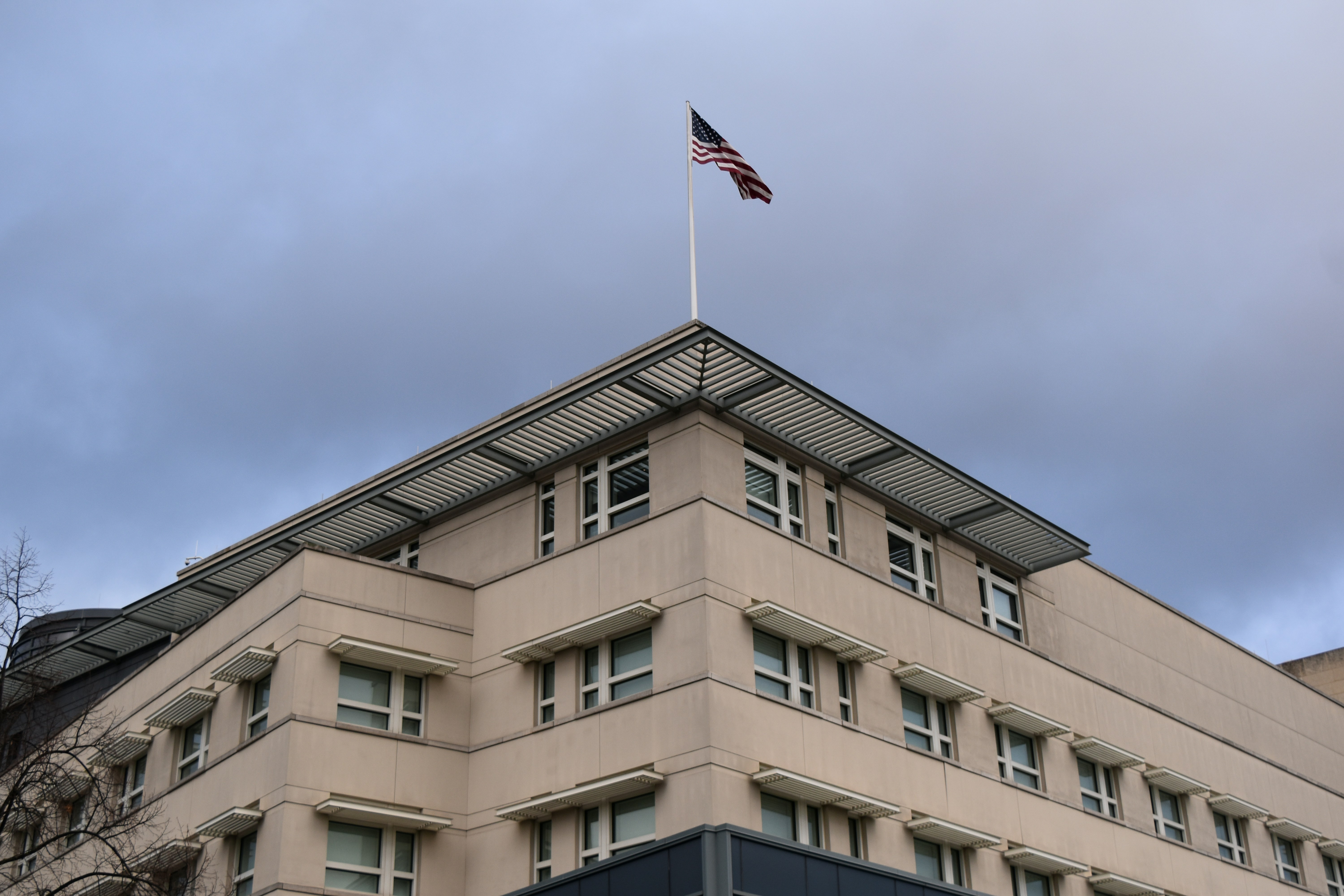 A tall building with a flag on top of it
