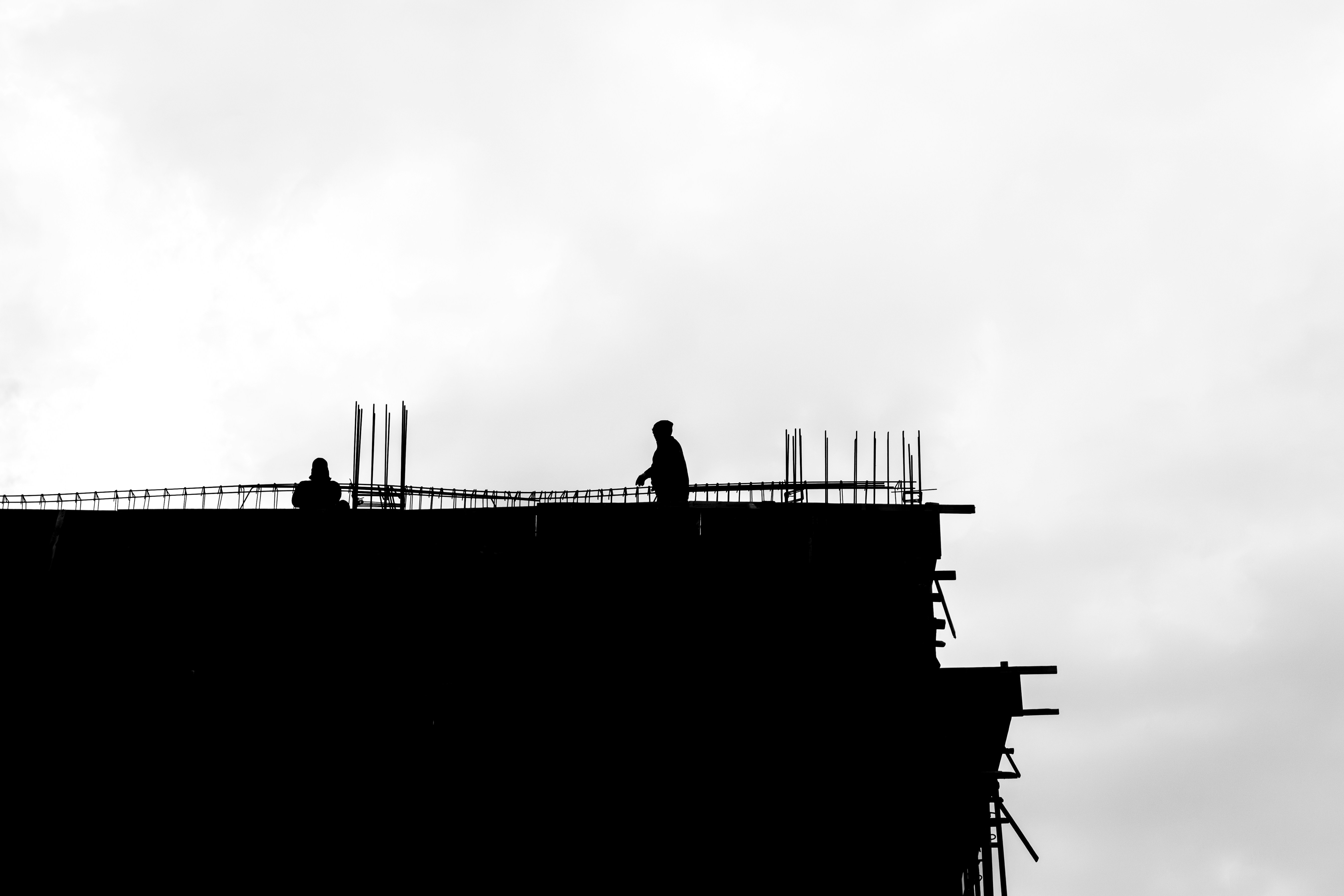 A black and white photo of a building under construction