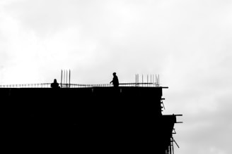 A black and white photo of a building under construction