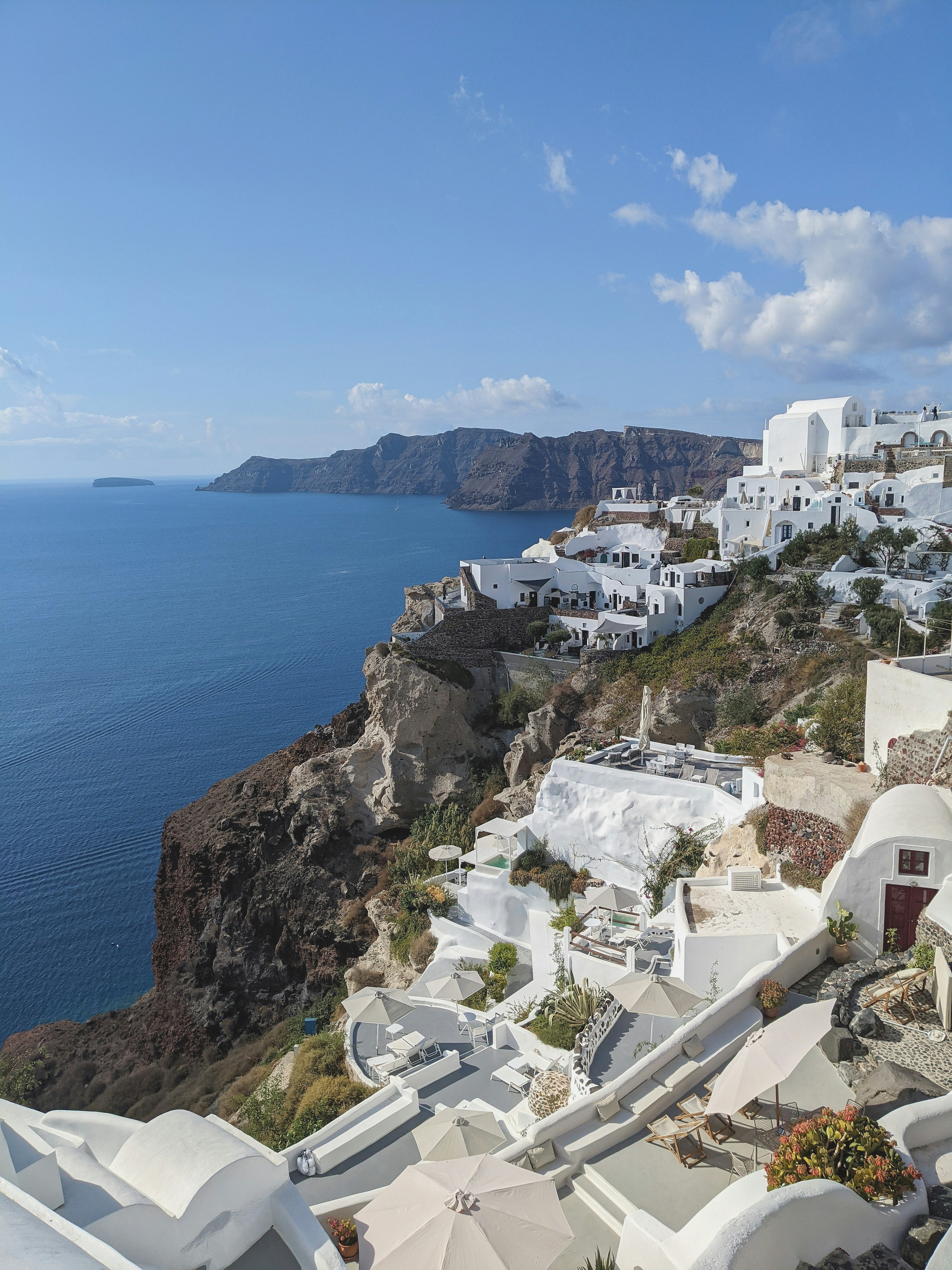 Premium white Aegean-style luxury villa with cascading terraces, infinity pool and panoramic Bodrum bay sea view, warm afternoon light
