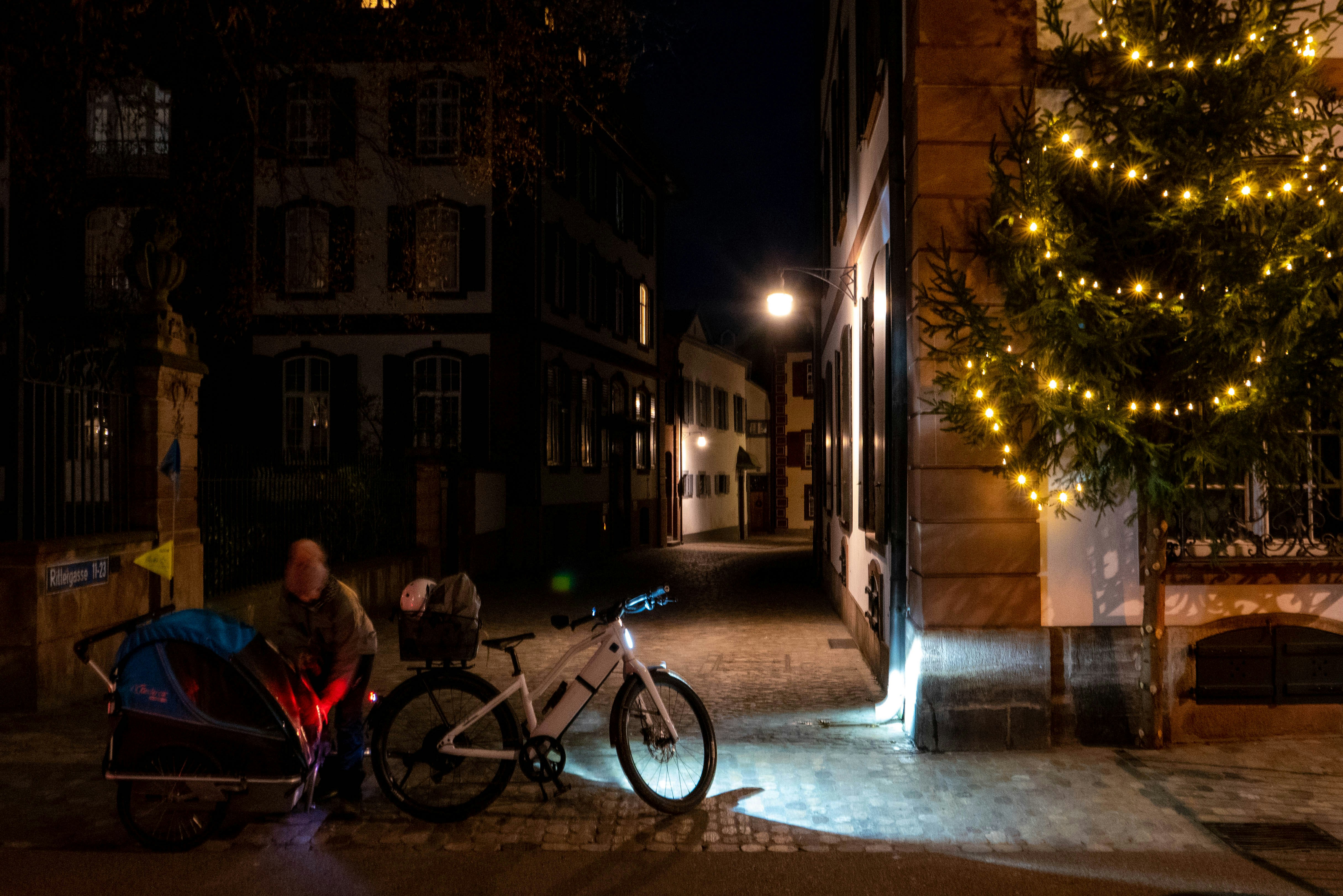 A bicycle parked next to a christmas tree