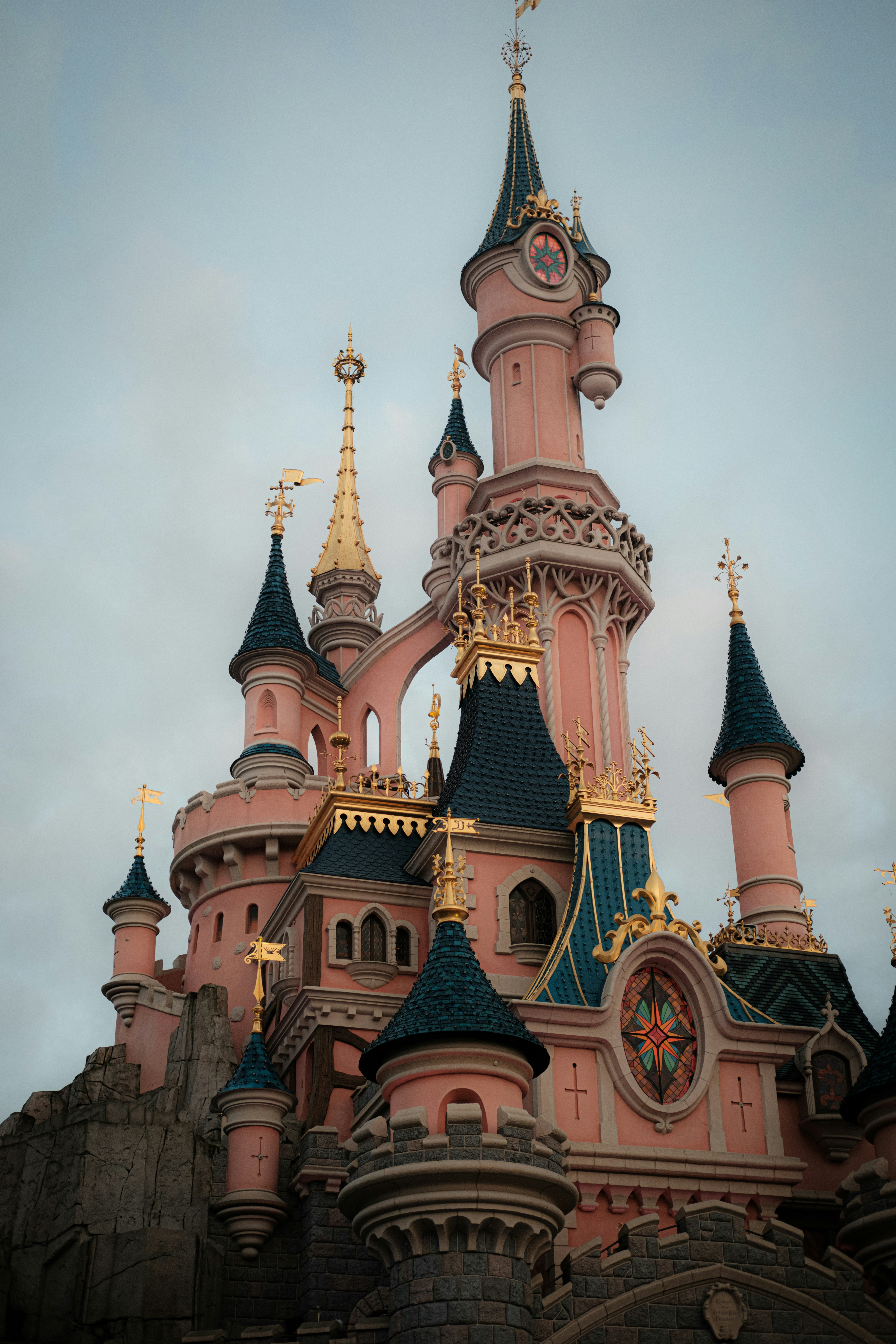 Soft pink illustrated children's book cover with fairy tale castle