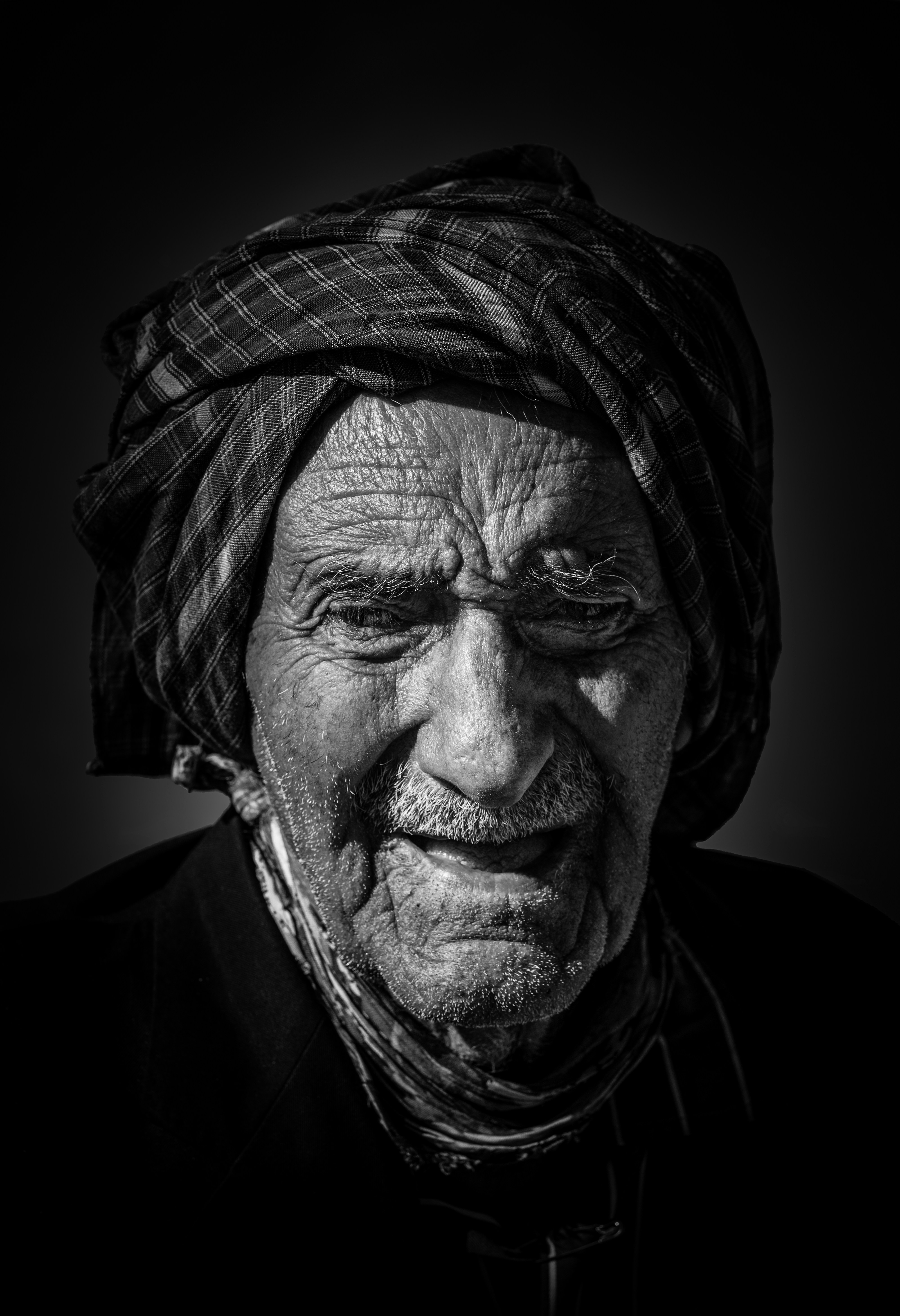 A black and white photo of an old man