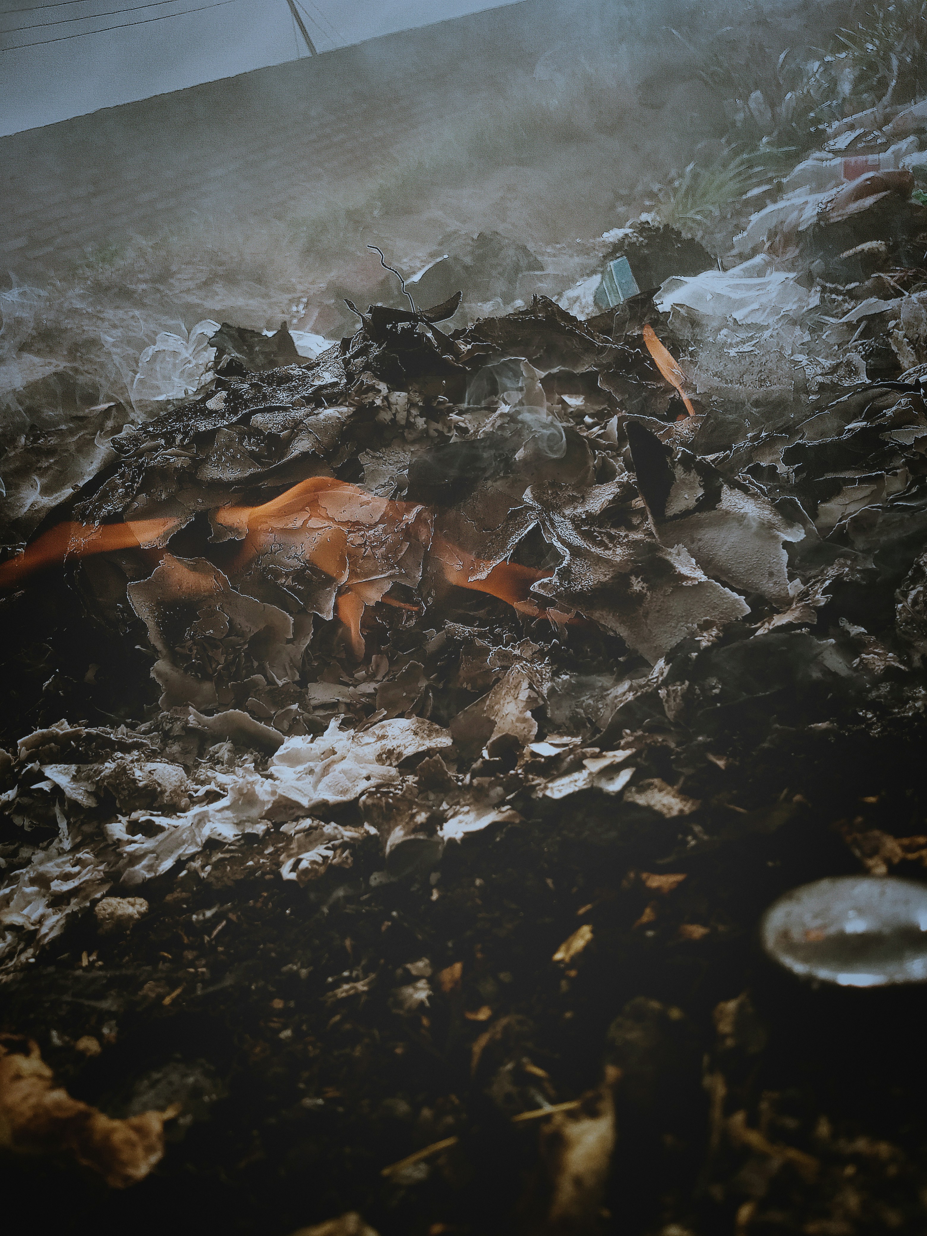 A pile of garbage sitting on top of a pile of dirt