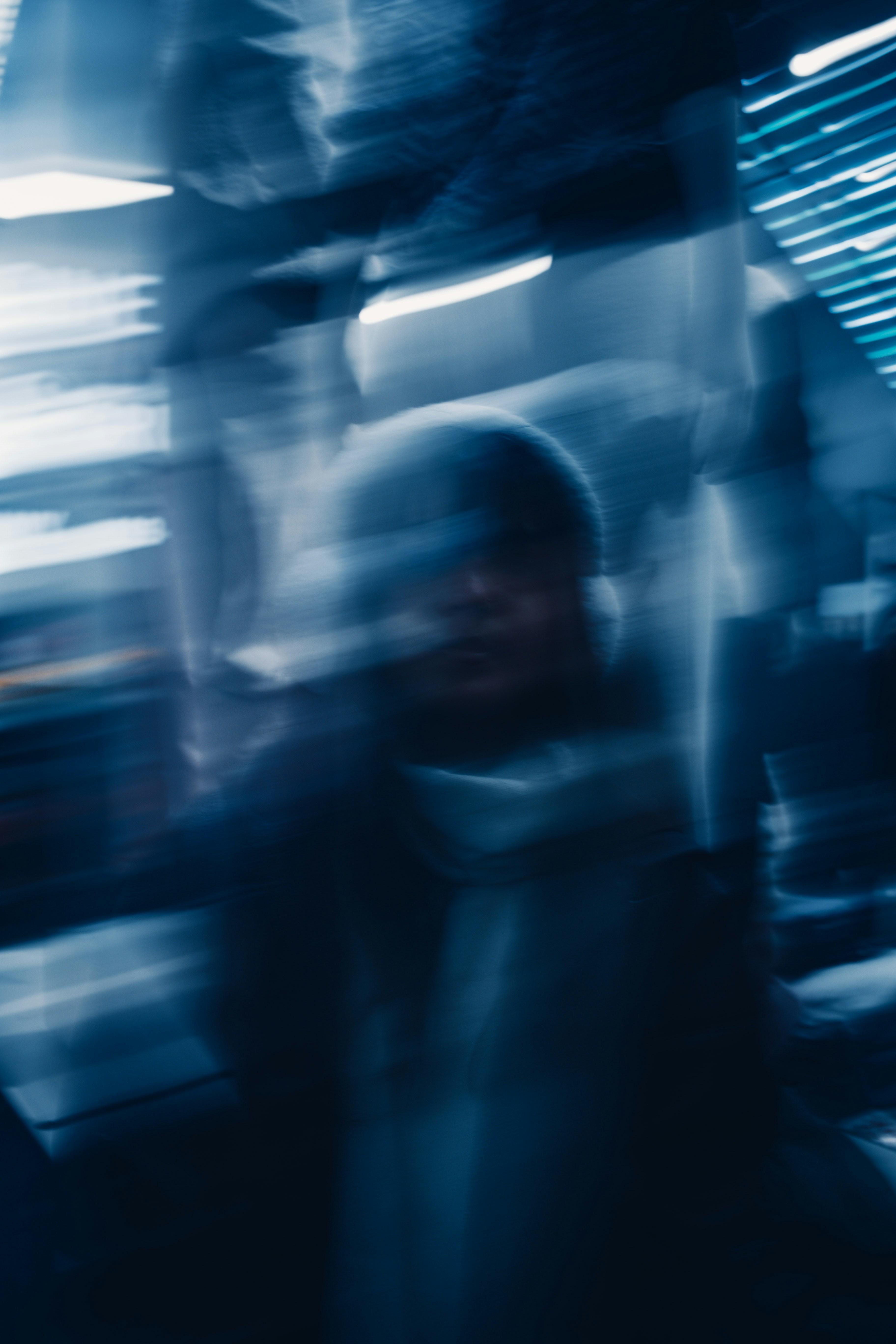 A blurry photo of a person walking down a street