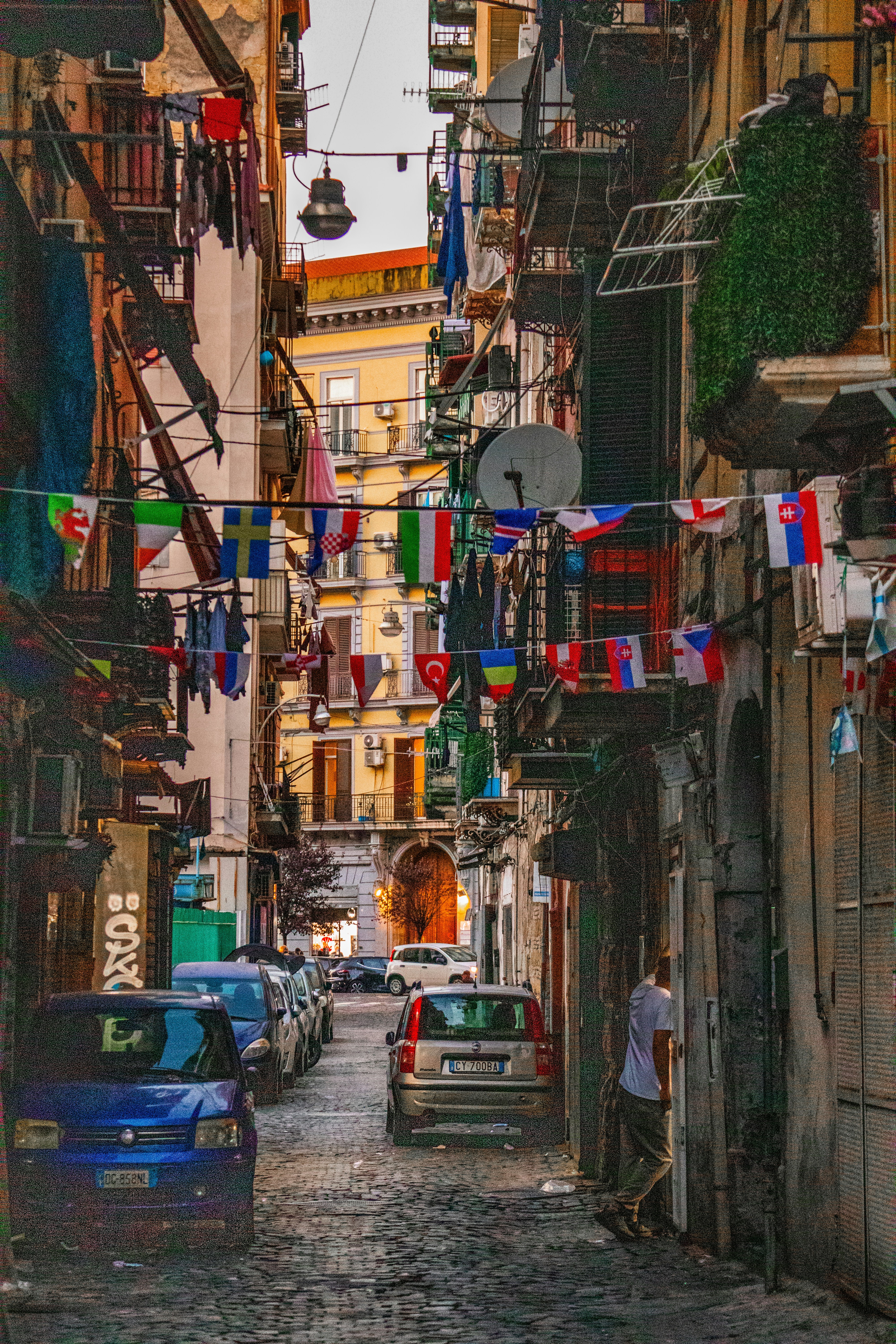 A narrow street with cars parked on both sides