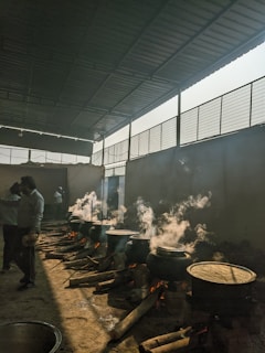 A group of people cooking food inside of a building