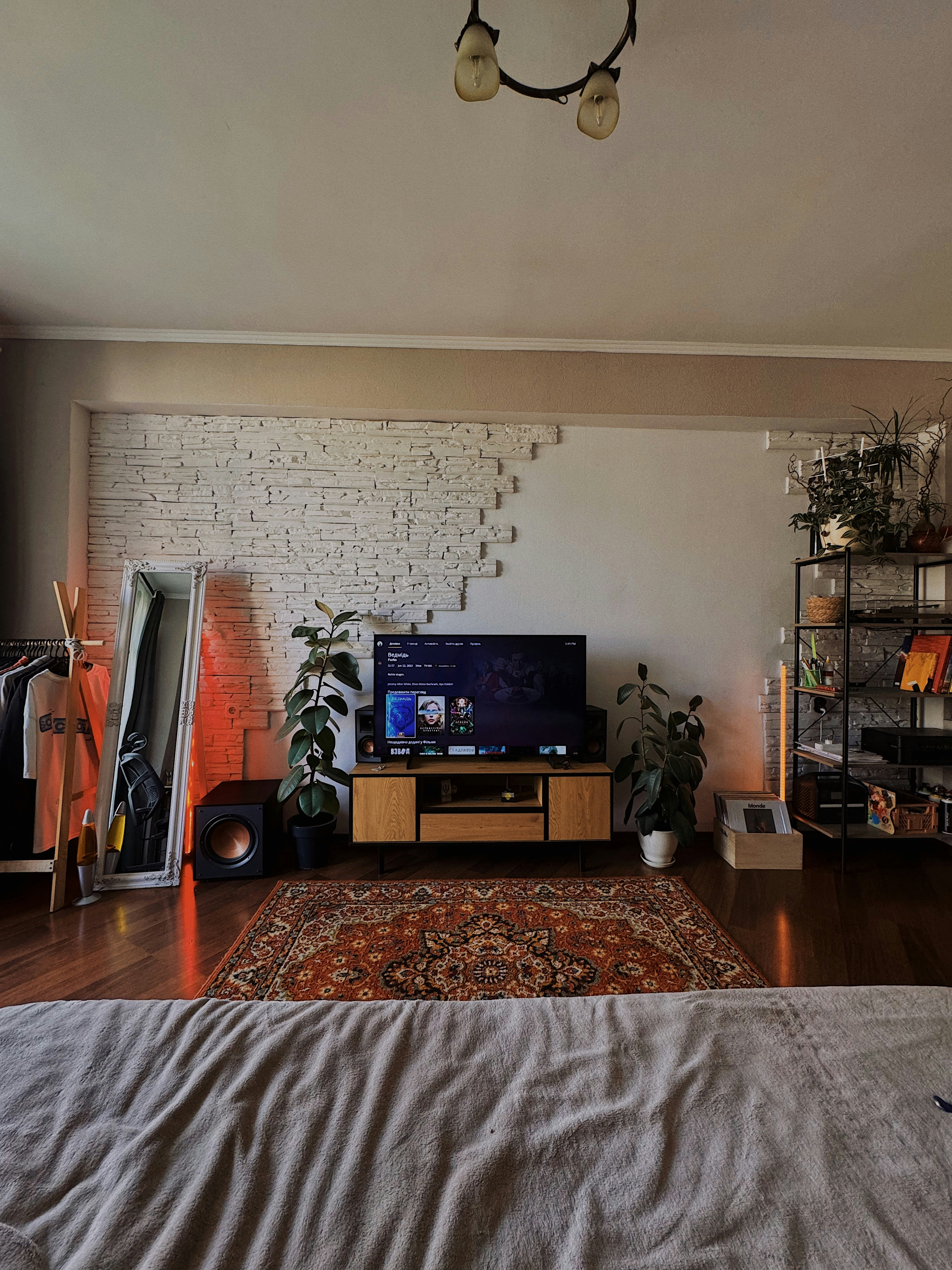 A bedroom with a large bed and a television