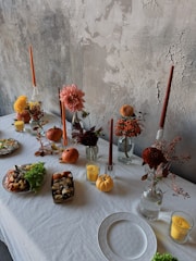 A white table topped with lots of food