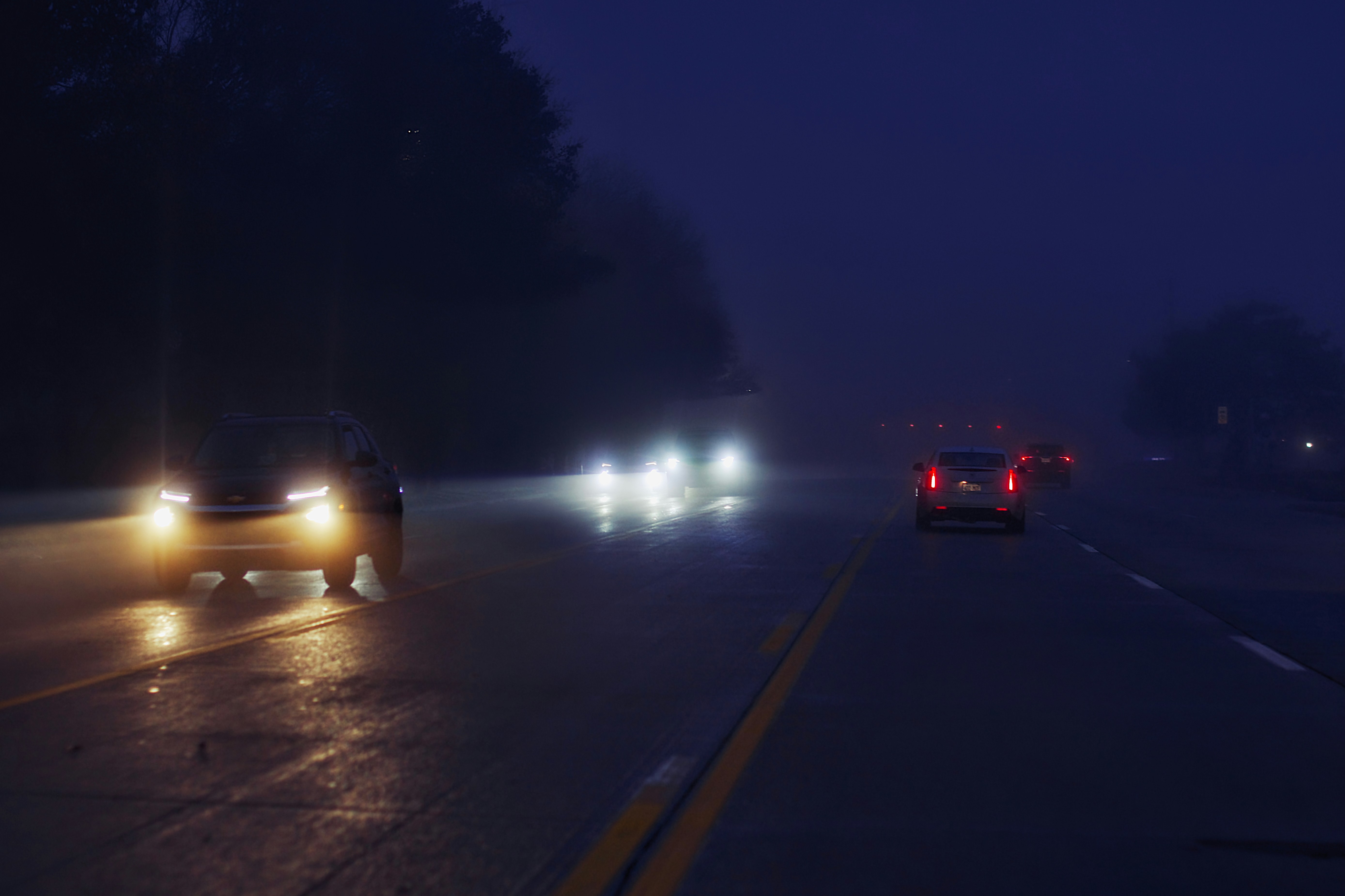 A car driving down a road at night