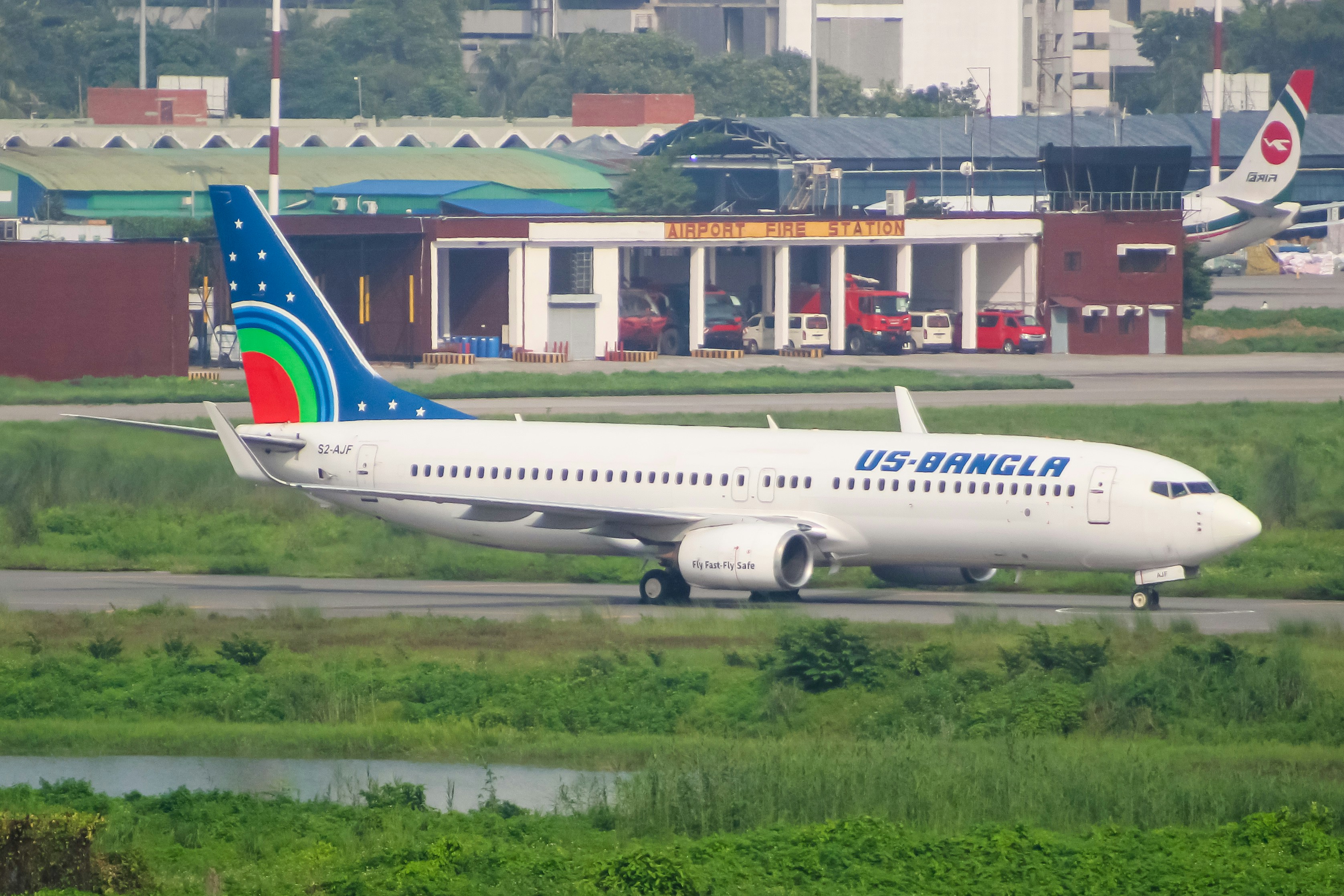 A large jetliner sitting on top of an airport runway, Us Bangla Airlines Boeing 737-800