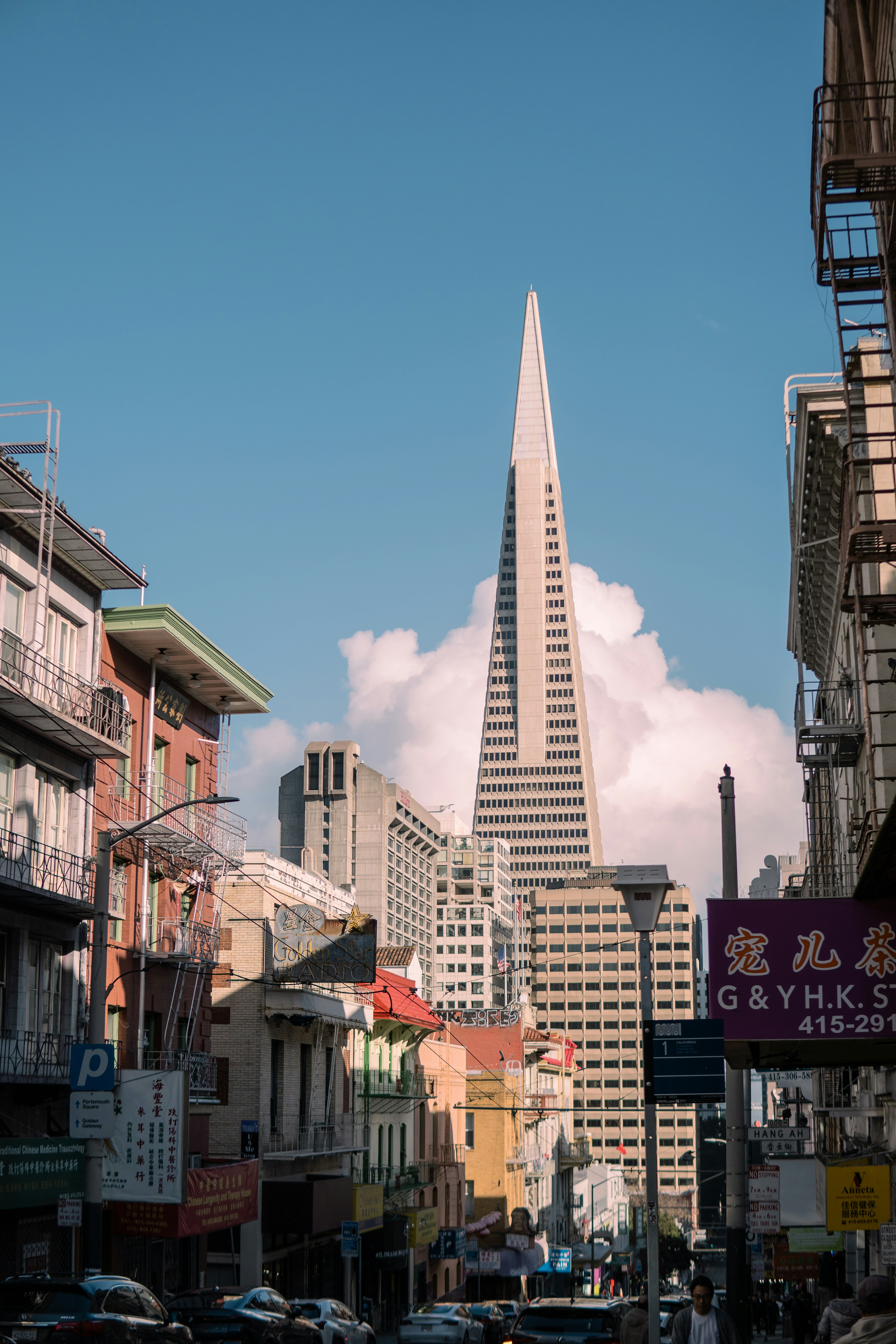A city street filled with lots of tall buildings