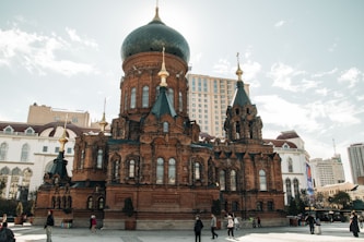 A large building with a green dome on top of it