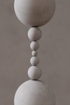 A close up of a sculpture of a ball and a bead