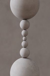 A close up of a sculpture of a ball and a bead