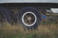An old truck is sitting in the grass